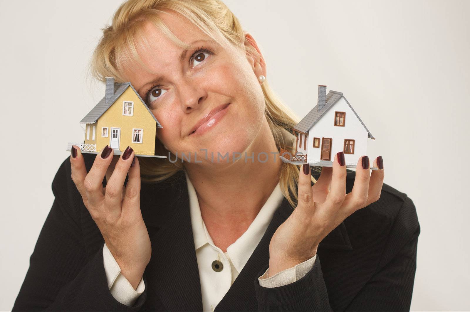 Female dreaming while holding two houses.