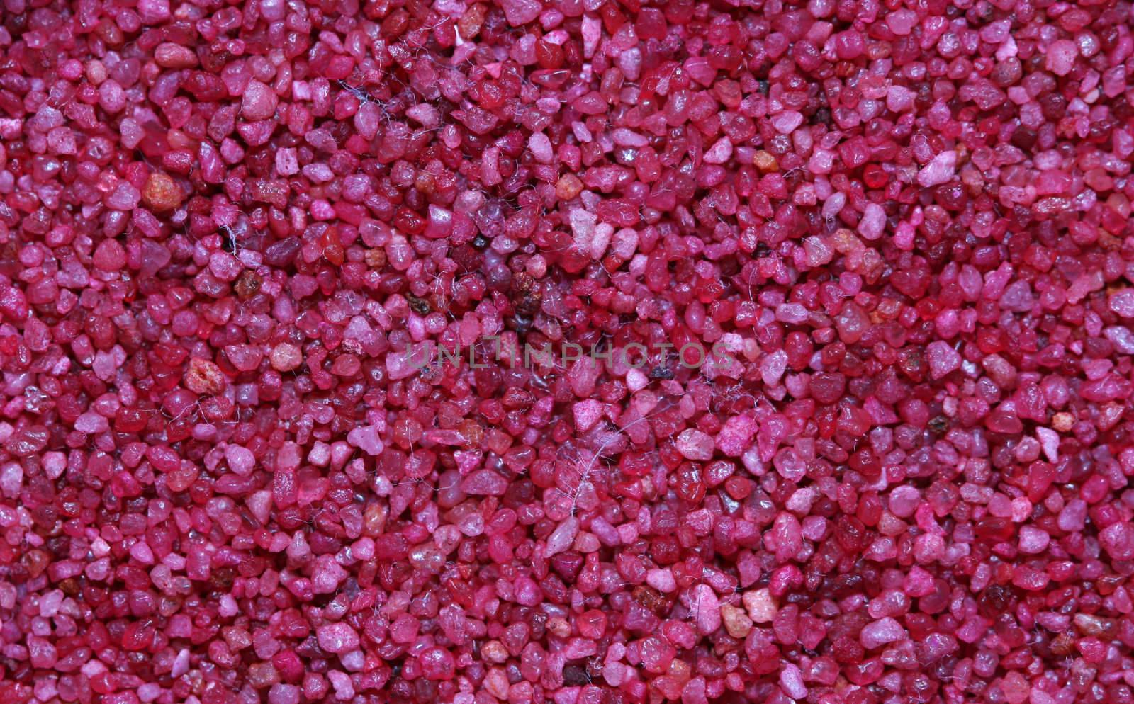 A macro shot of the pattern in pink colored sand