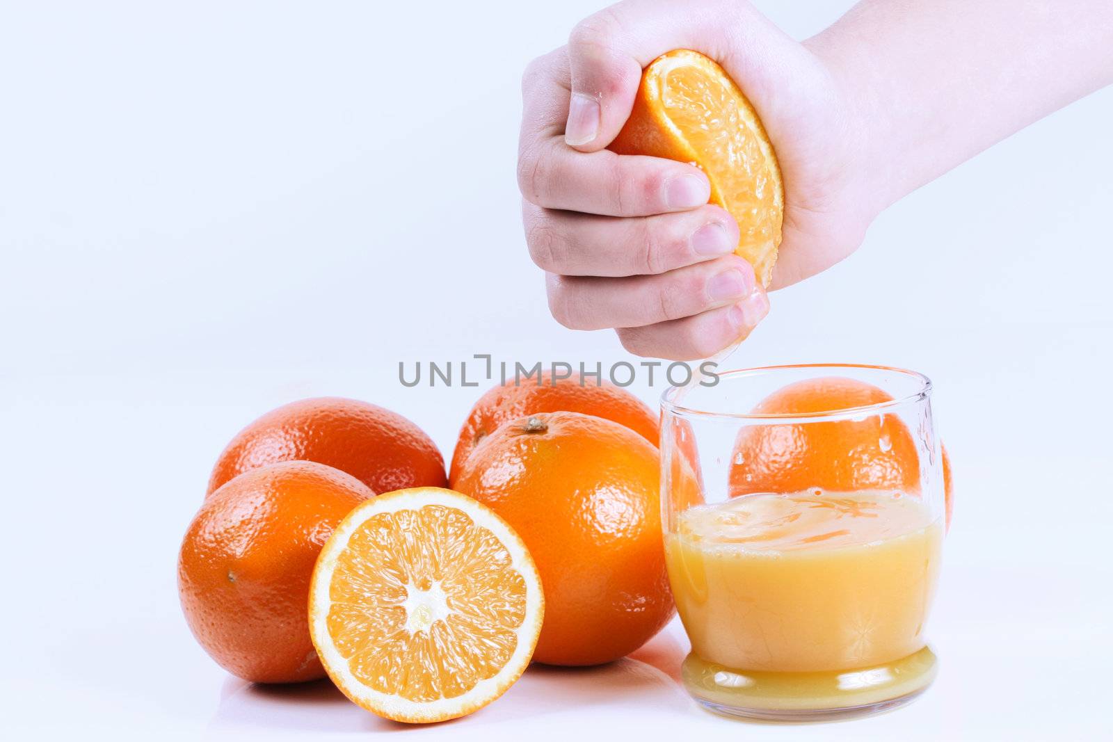 Fresh hand squeezed orange juice. Isolated on white.