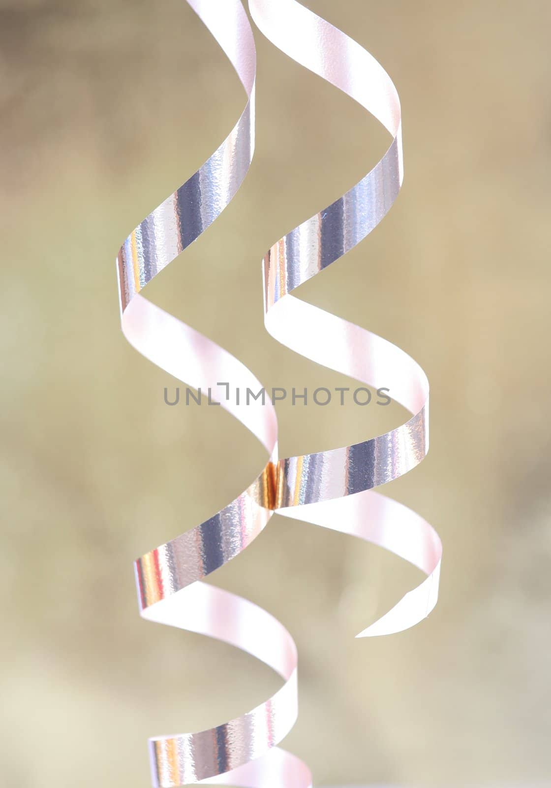 Gold satin ribbons curled elegantly, holiday party theme