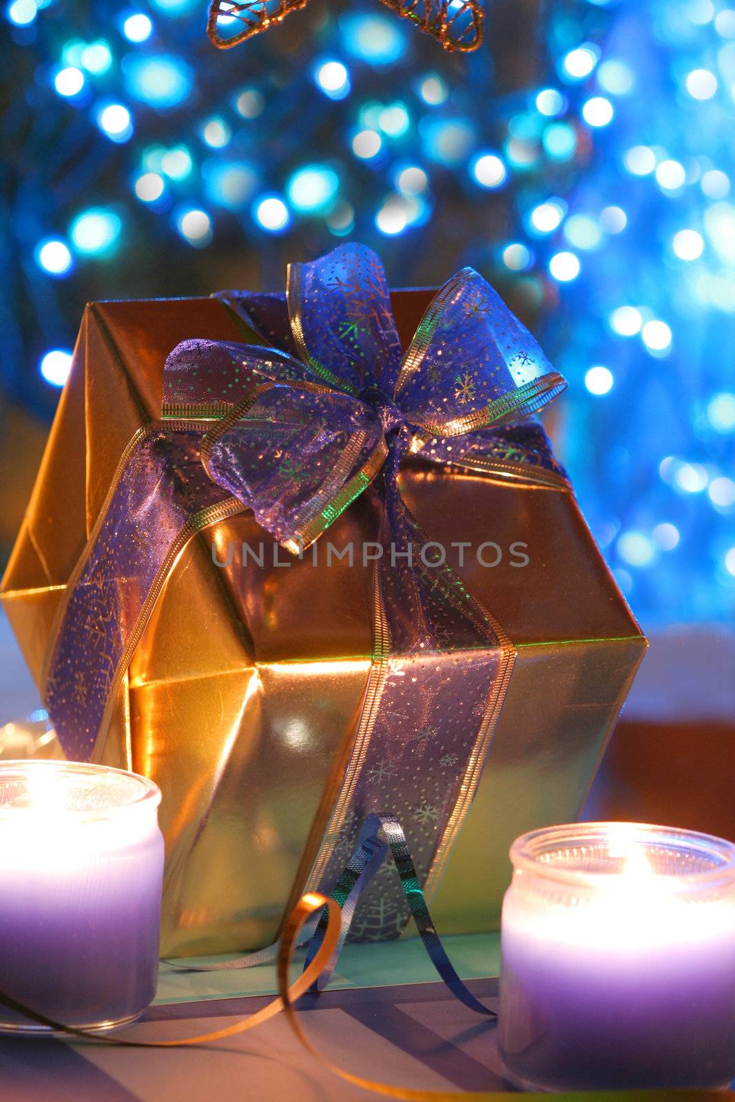 Elegant gold present with blue ribbons against backdrop of blue lights