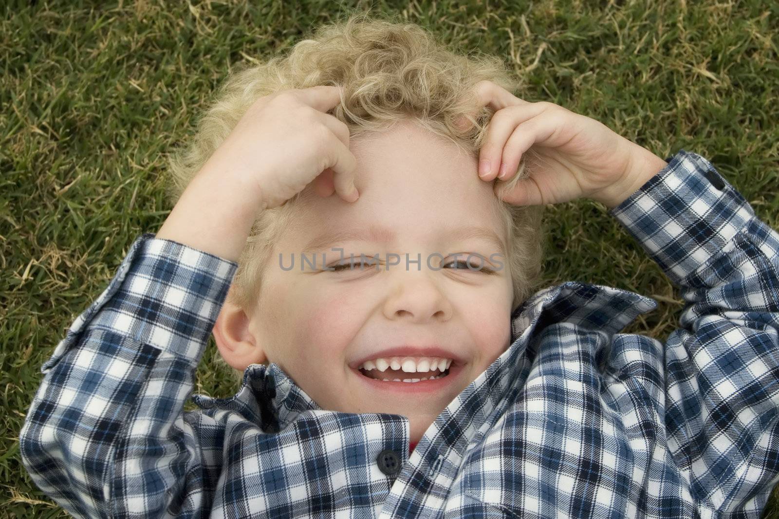 Close Up of a Little Boy Laughing in the Grass