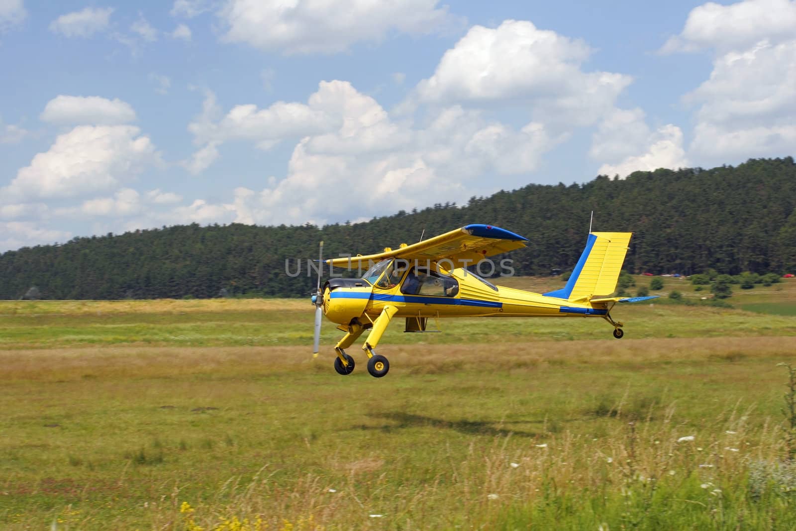 Yellow plane taking off