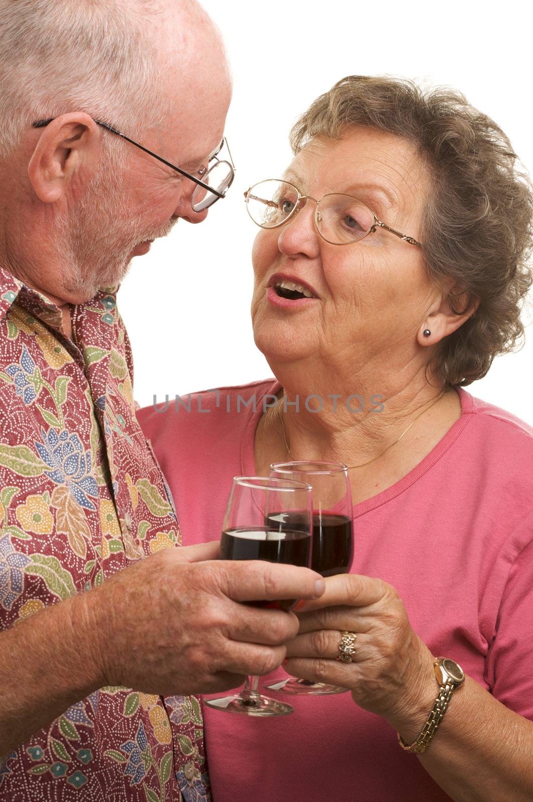 Happy Senior Couple toasting with Winee glasses.