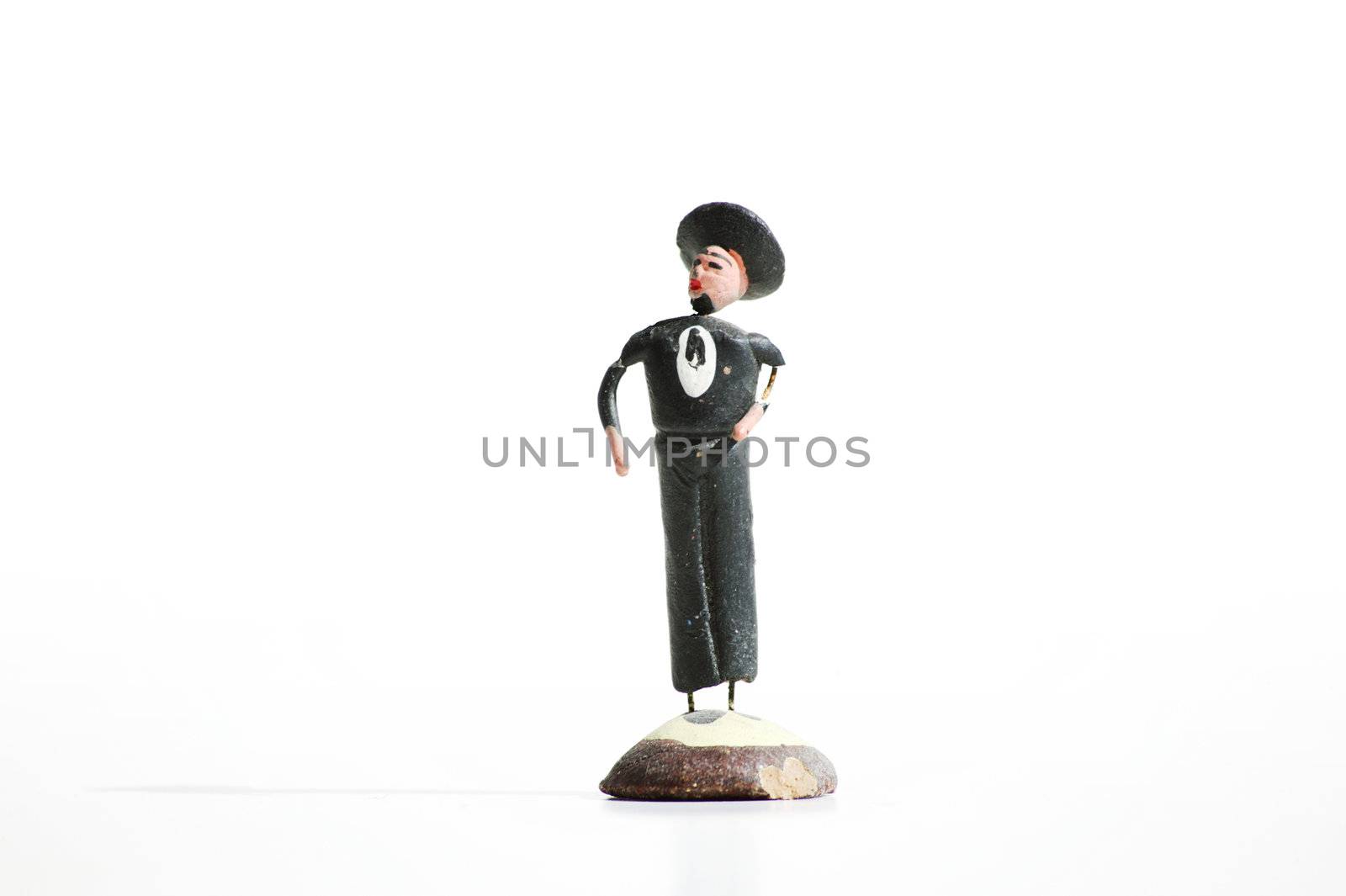 Whimsical mexican clay toy cowboy on a white background.