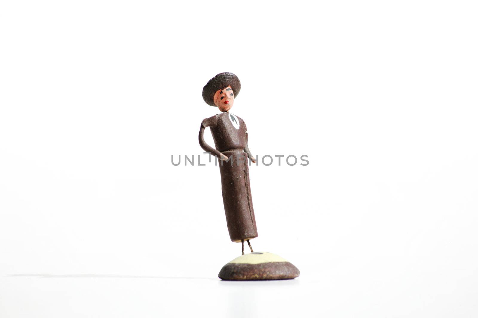 Whimsical mexican clay toy cowboy on a white background.