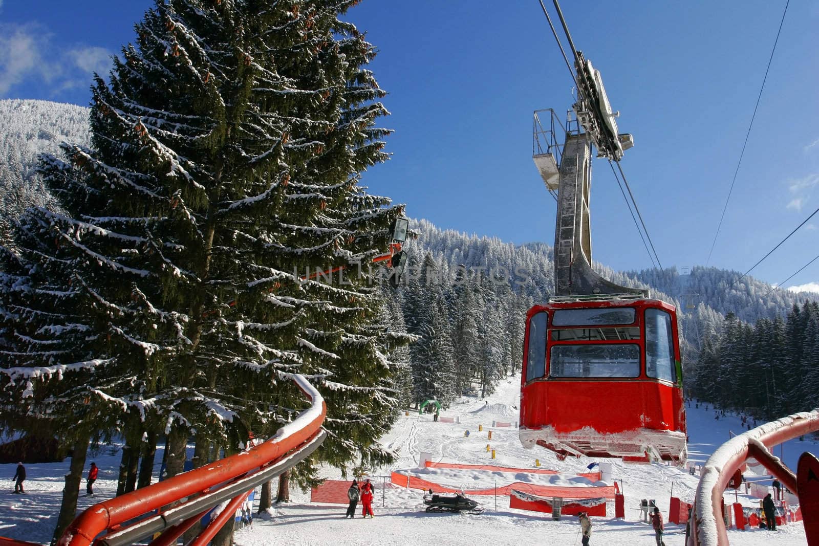 Winter landscape with a red cable car.