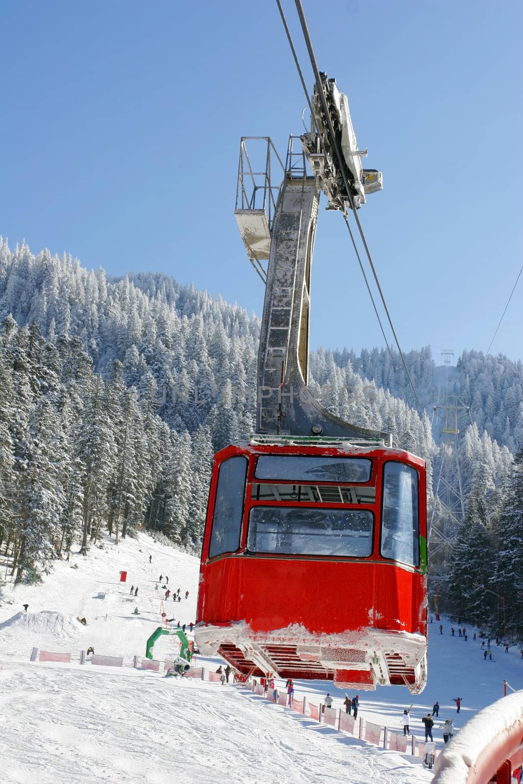 Winter landscape with a red cable car.