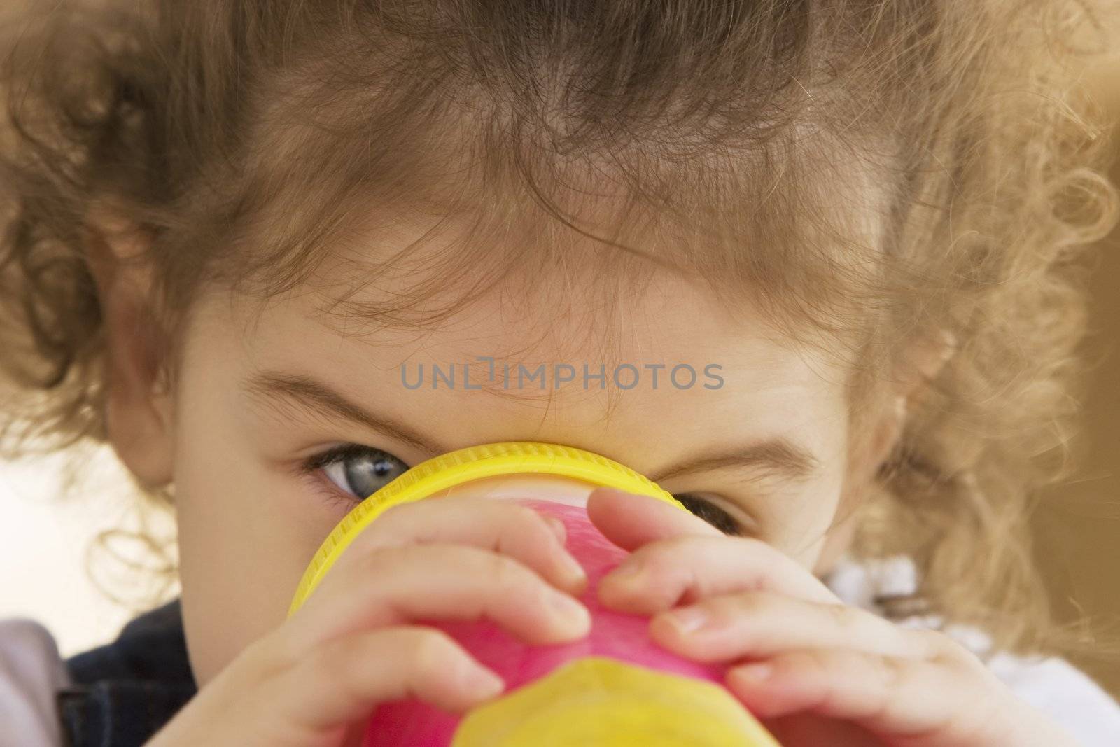 Little girl drinking from a pink cup by Creatista