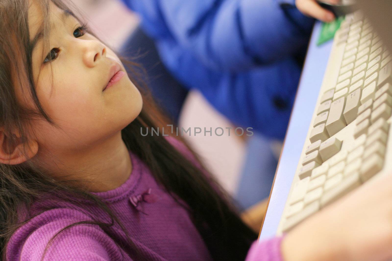 Small child enjoying time on the computer. by jarenwicklund