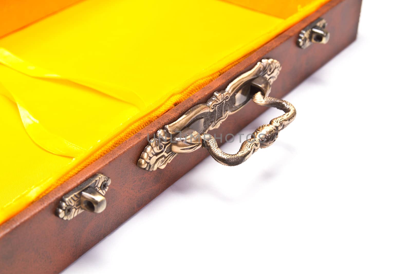 empty box with yellow inner lining on white surface with detail on handle and locks