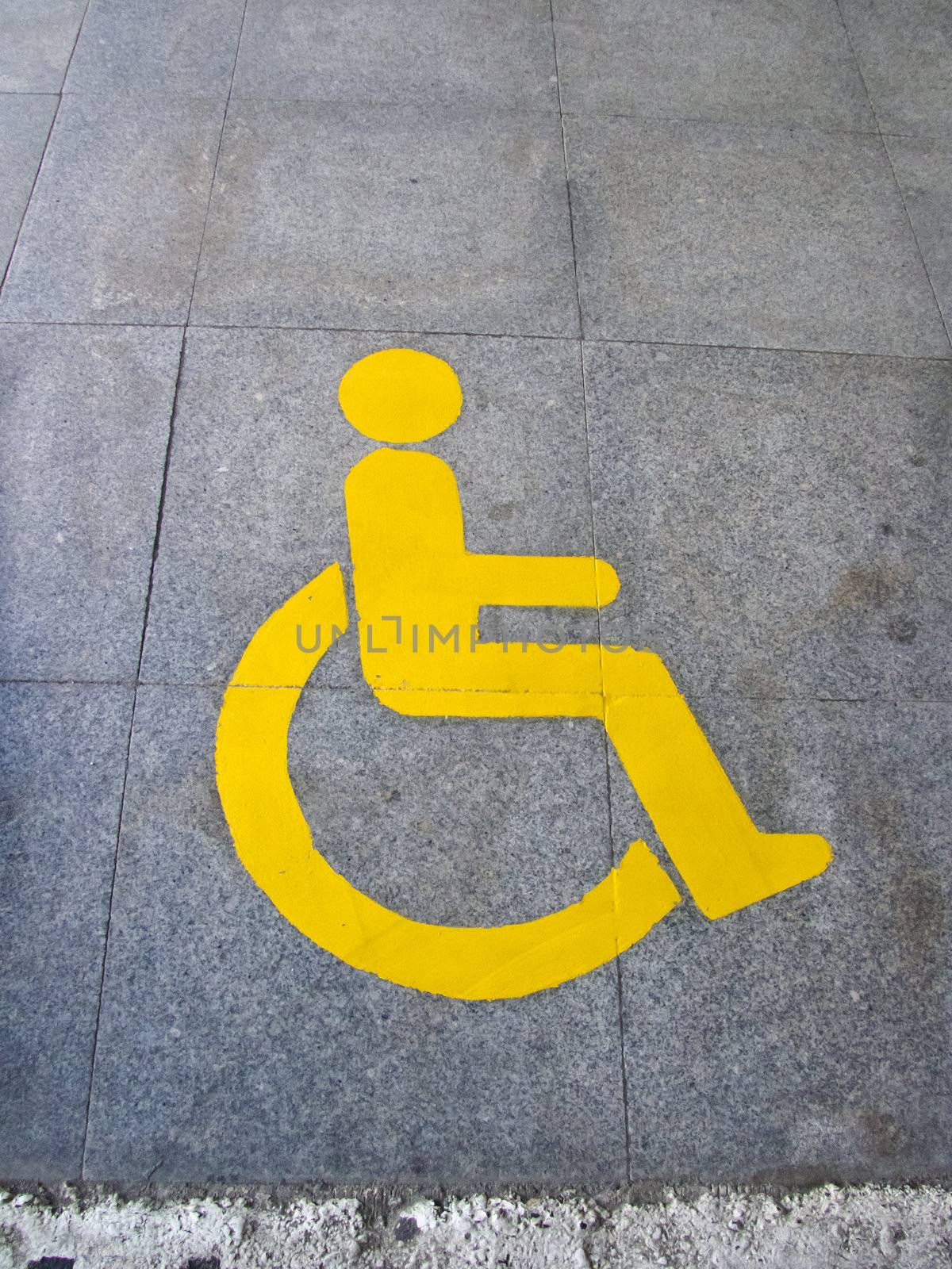 Yellow handicapped sign of floor tile