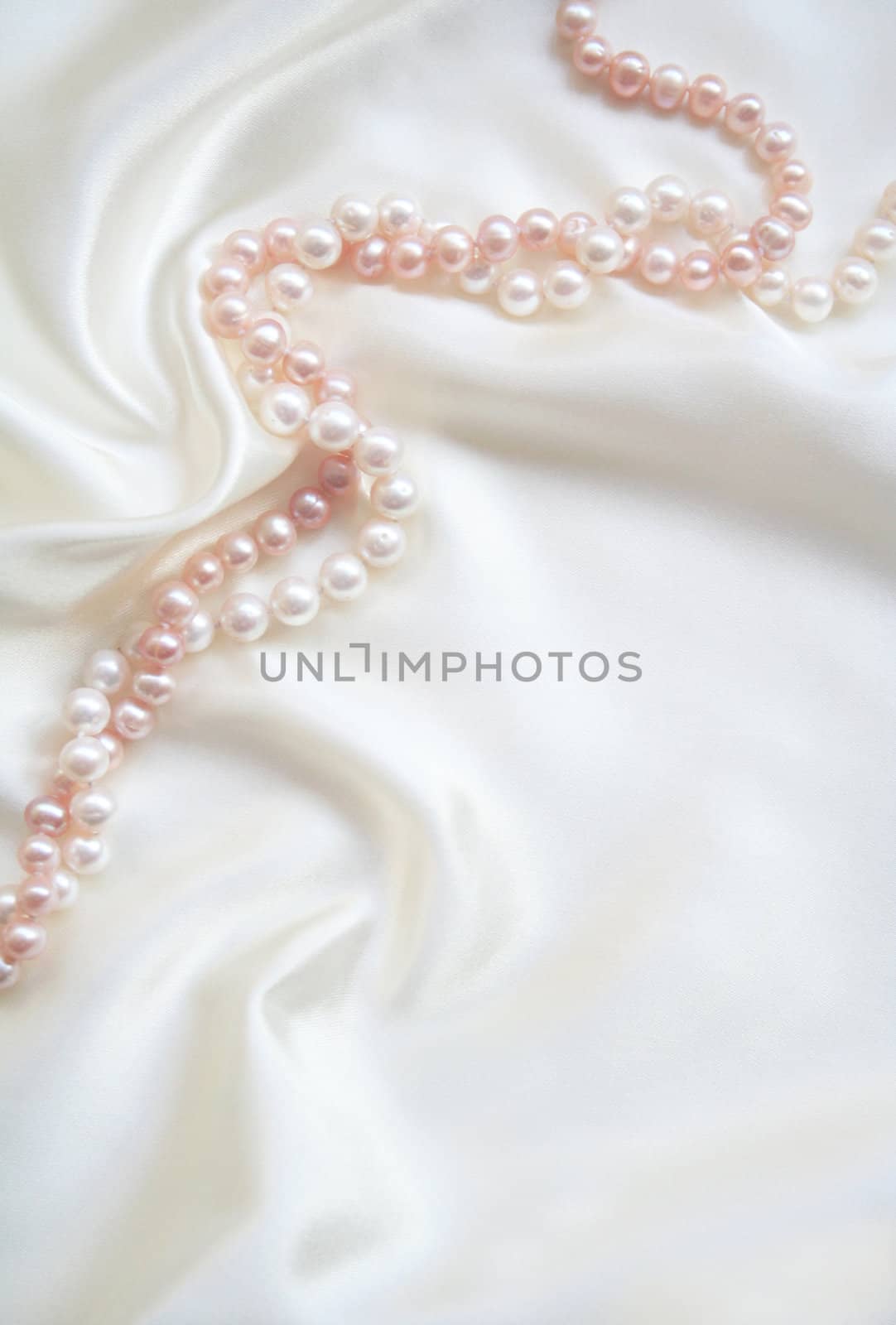Smooth elegant white silk with white and pink pearls can use as wedding background 