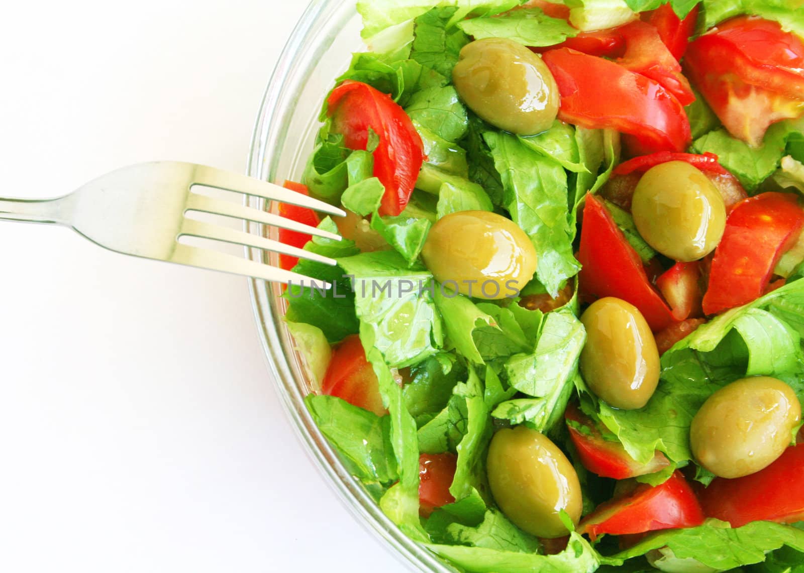 Healthy vegetarian Salad with olives and fork
