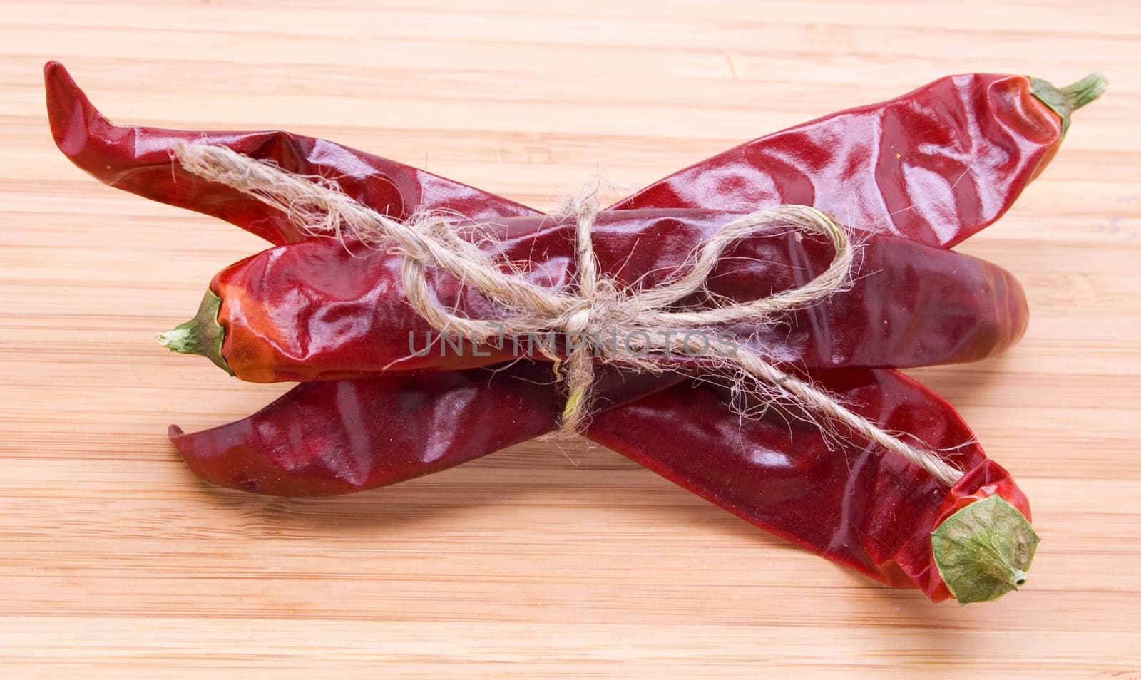 Colorful red peppers on wooden background 