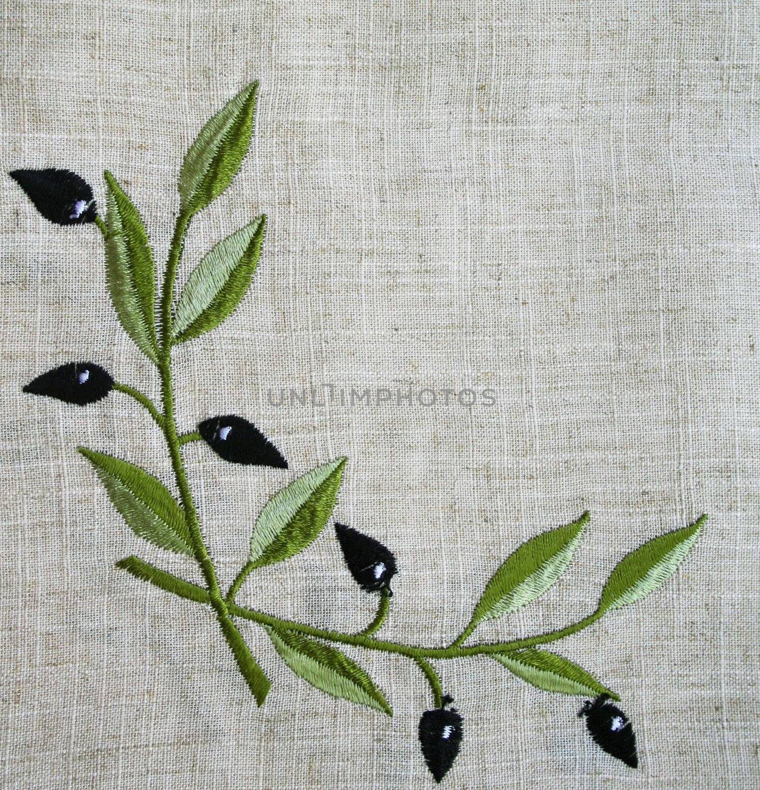 Embroidery of olive branch on linen beige fabric can use as background 