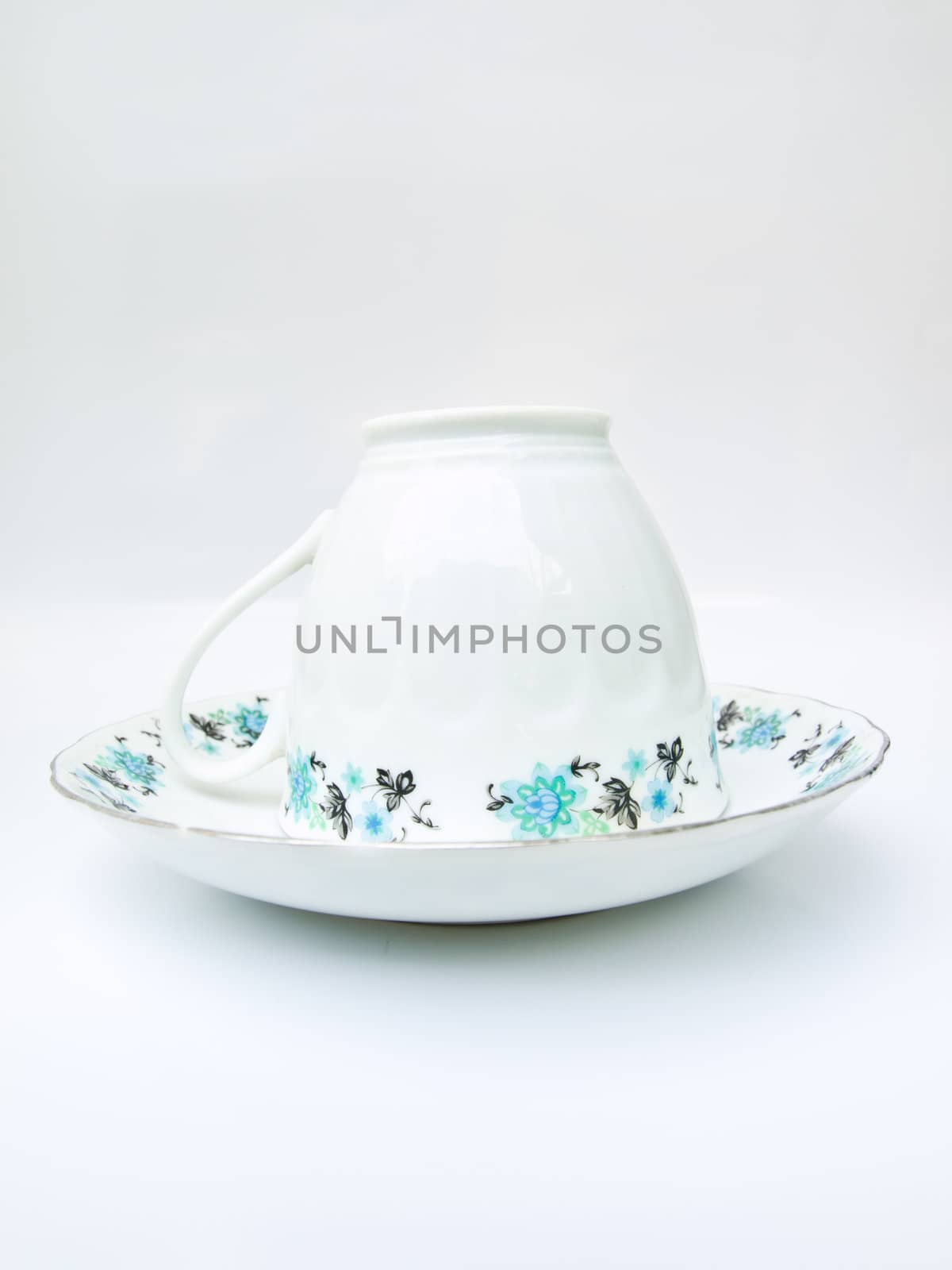 A floral pattern tea cup isolated on white background by gururugu