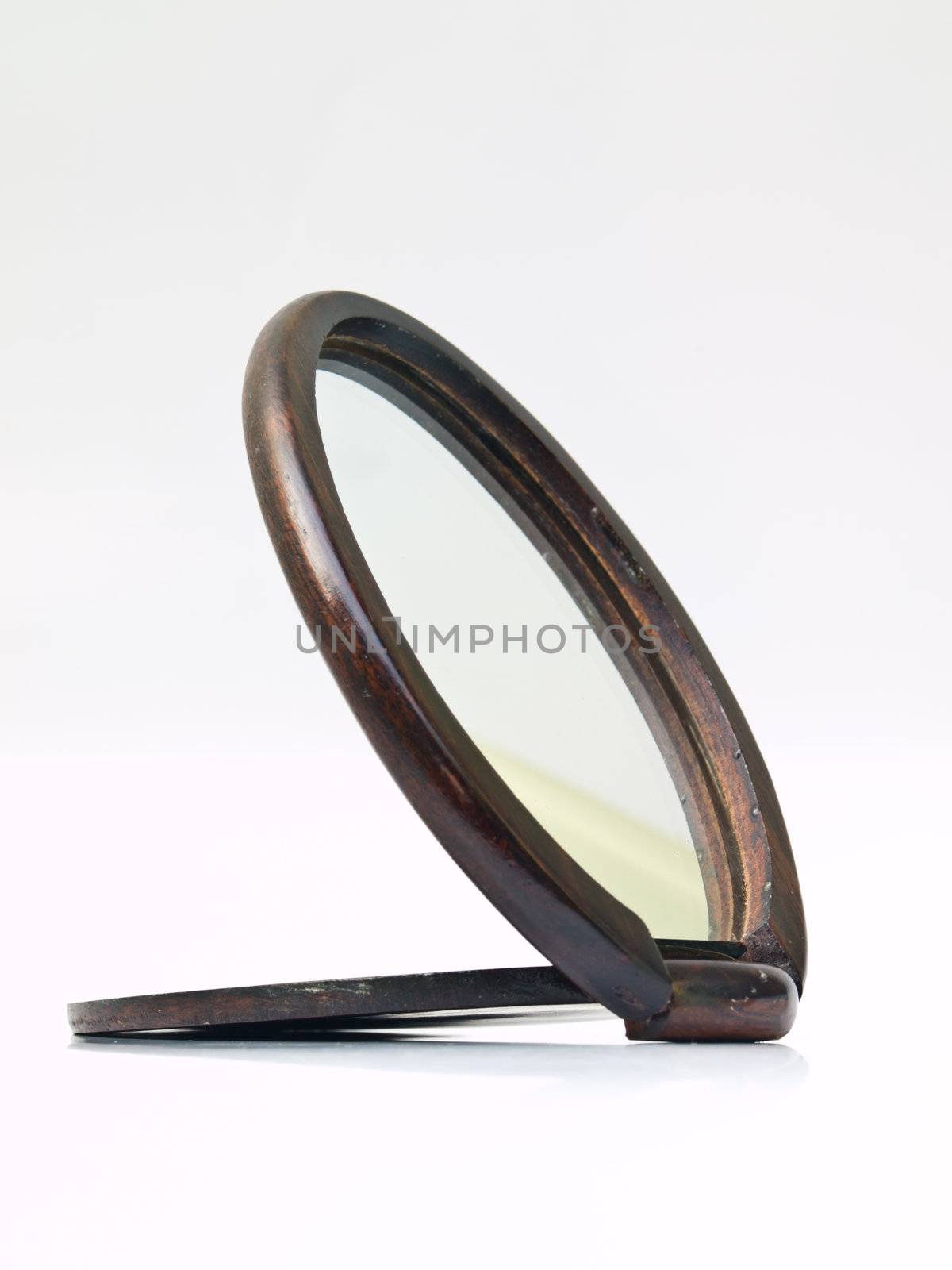 A wooden pocket makeup mirror isolated on white background