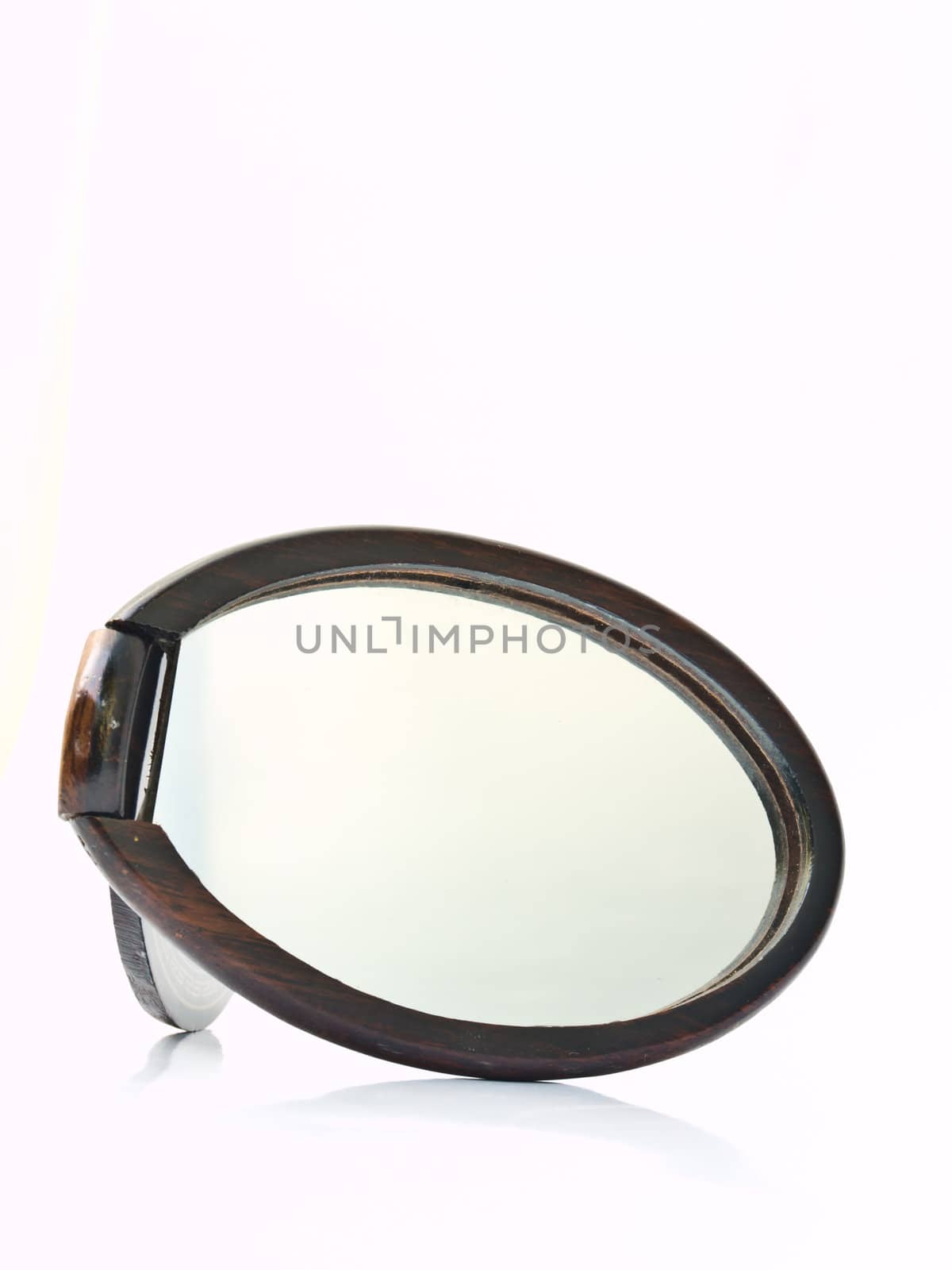 A wooden pocket makeup mirror isolated on white background