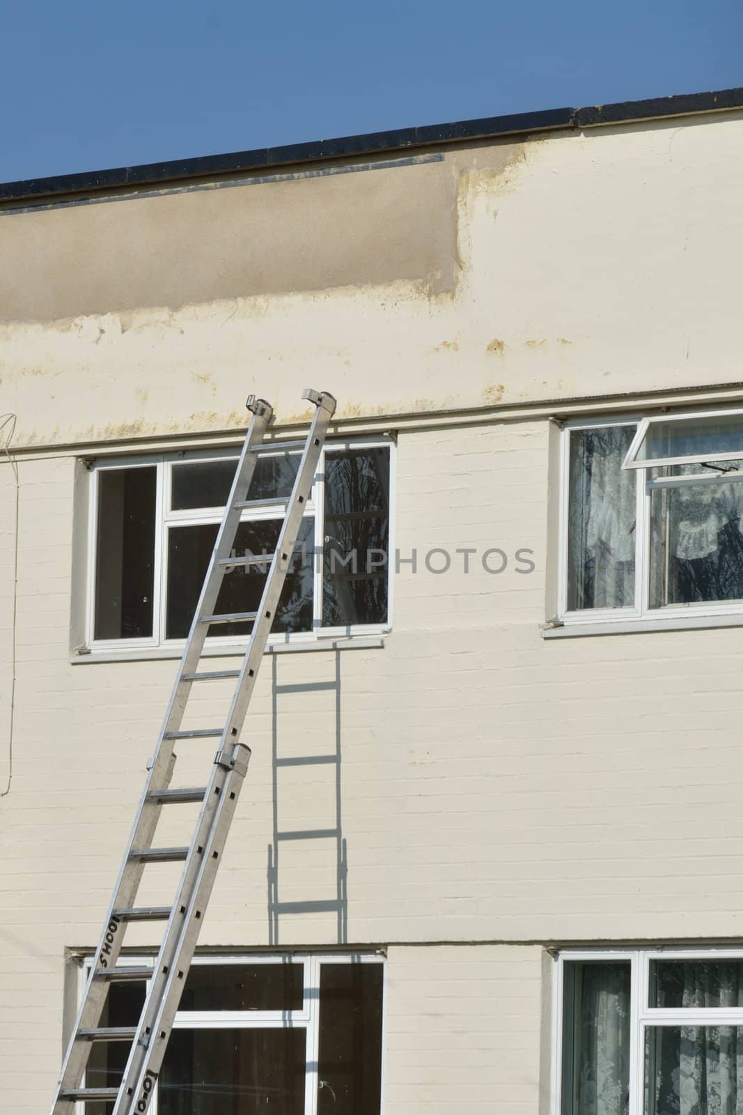 Ladder leaning against flat for repair
