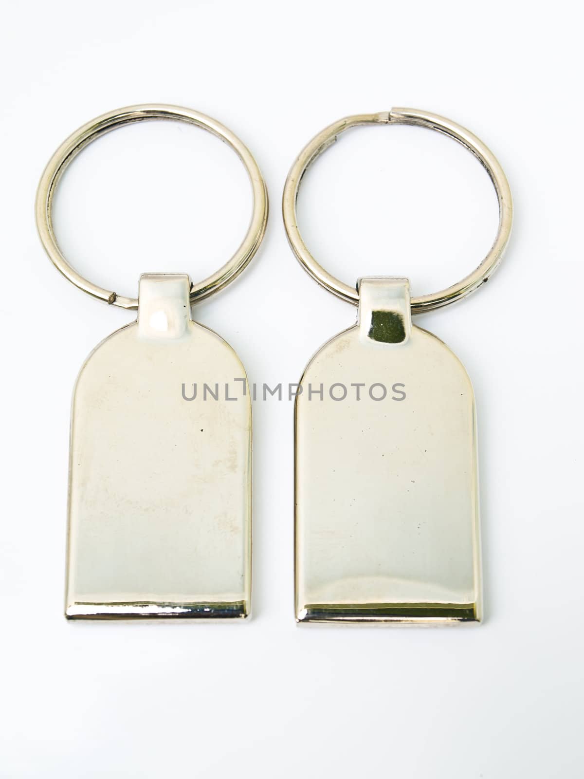 A pair of metalic trinket keychain isolated on white background