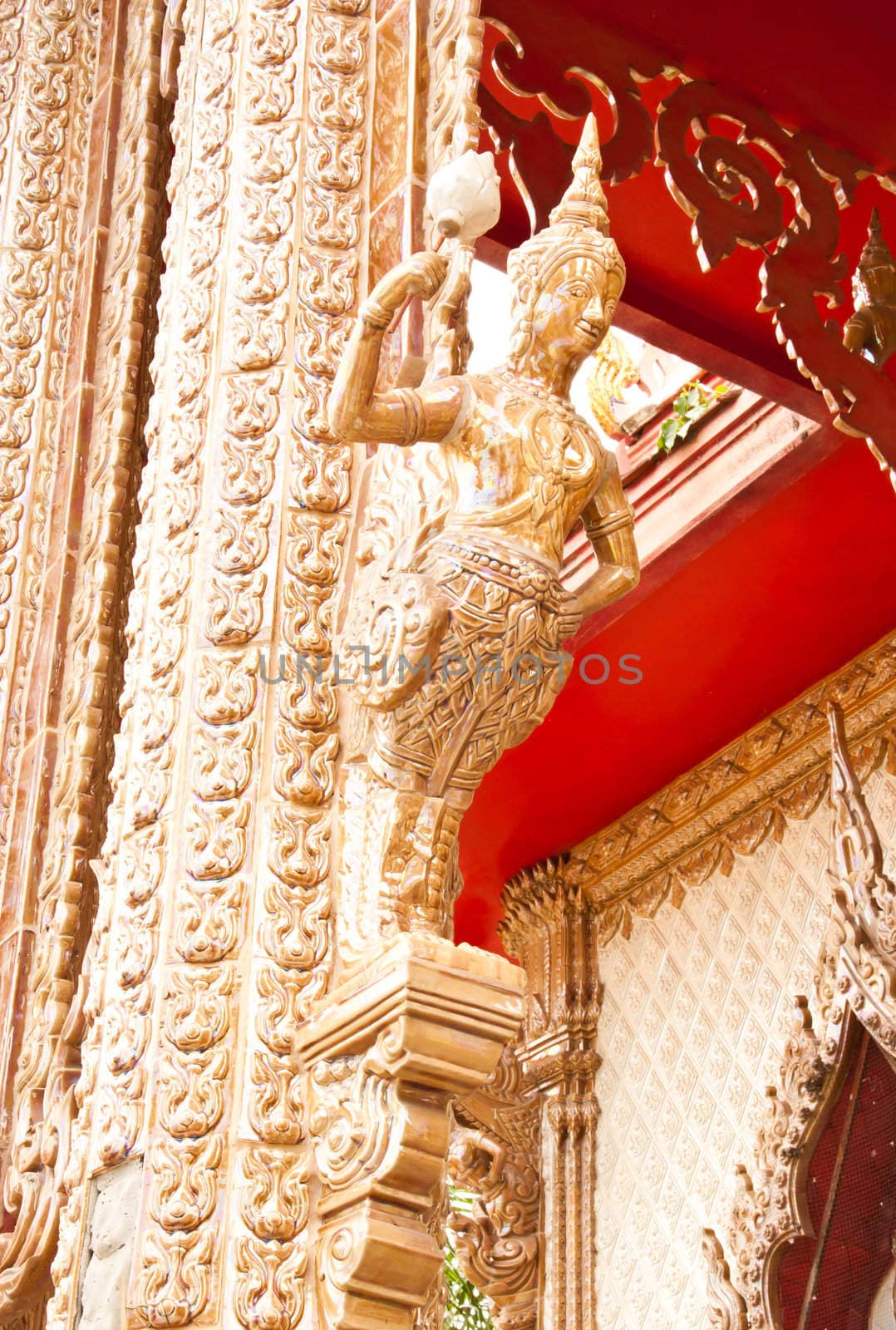 Phetchaburi, Thailand - June 13 : at wat kuti in Phetchaburi Province.
have the wall sculptures of traditional Thai style  and this is a pole of the temple in Thailand. The architecture is beautiful.