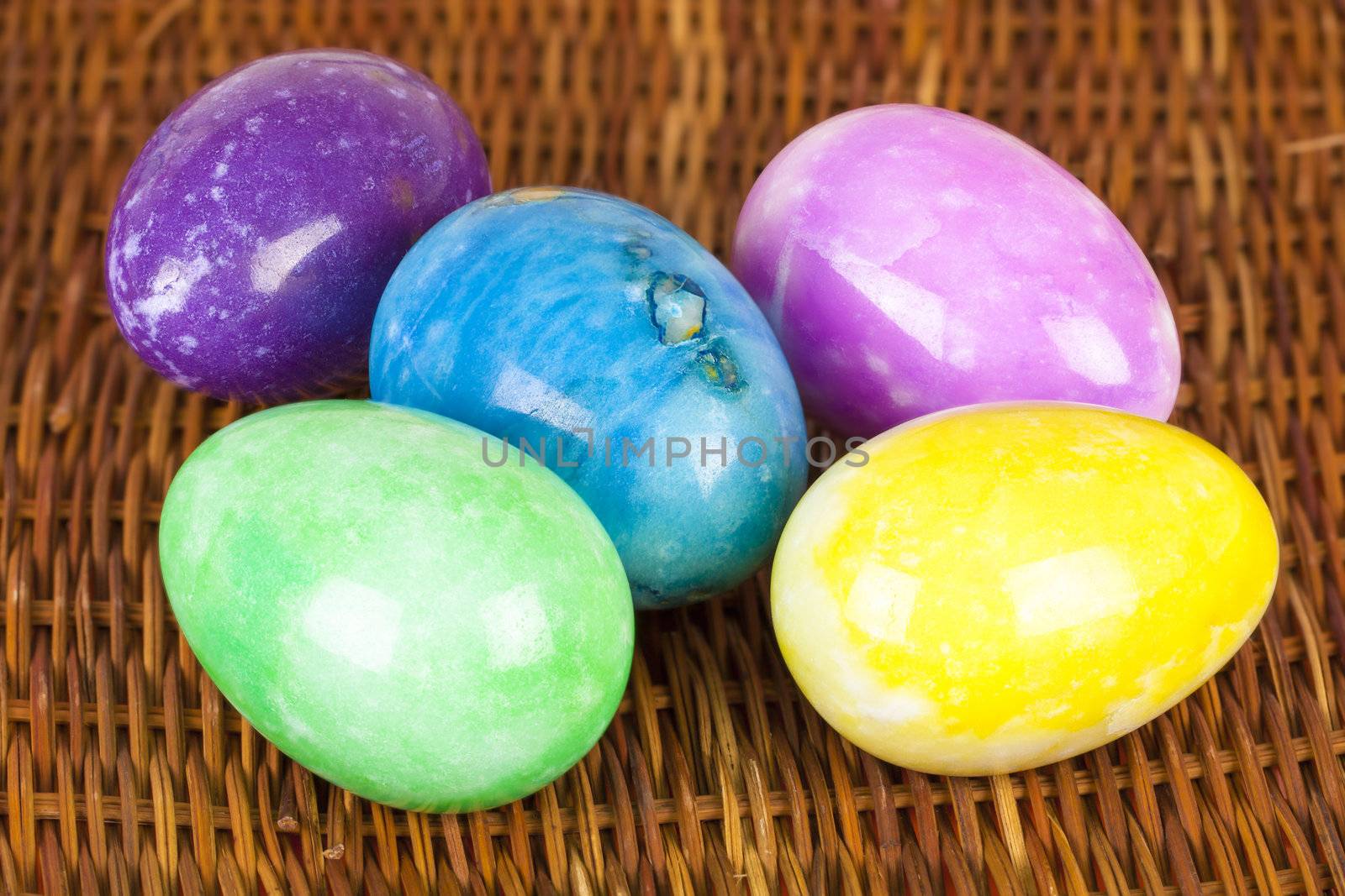 Easter eggs in different colors on the braided surface by A.L.
