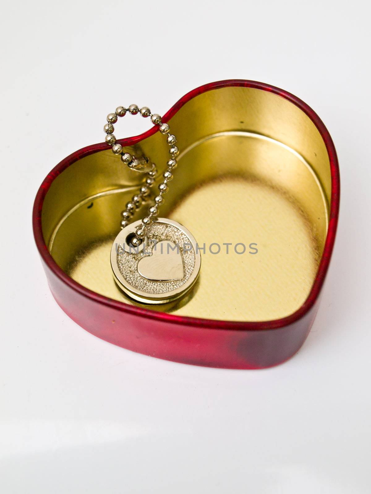 A golden stainless stell heart with a miniature heart keychain i by gururugu