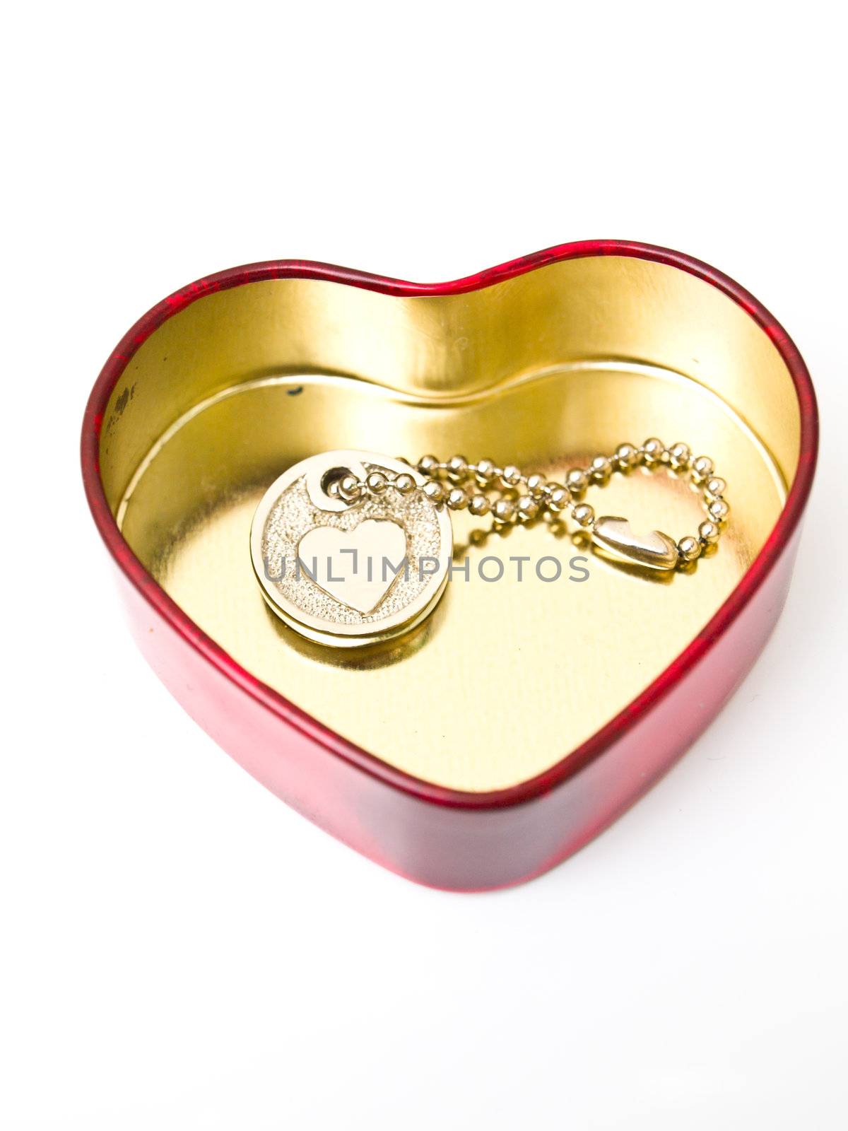 A golden stainless stell heart with a miniature heart keychain i by gururugu