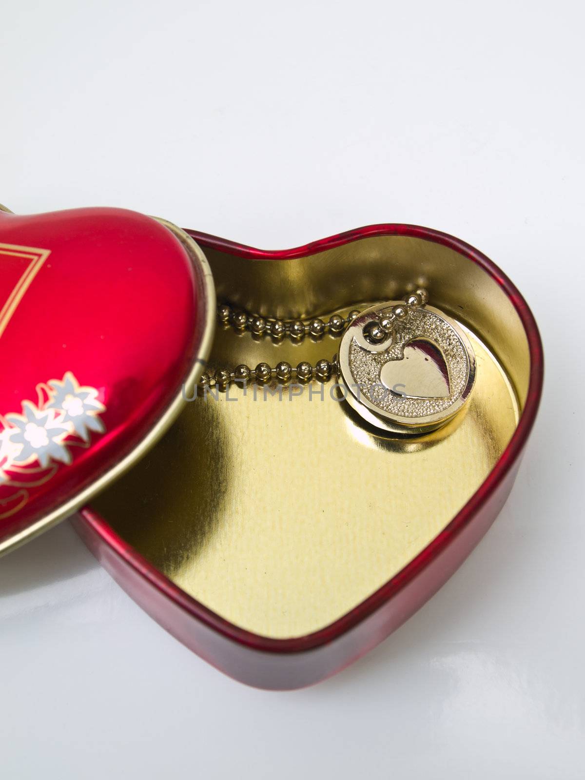 A golden stainless stell heart with a miniature heart keychain i by gururugu