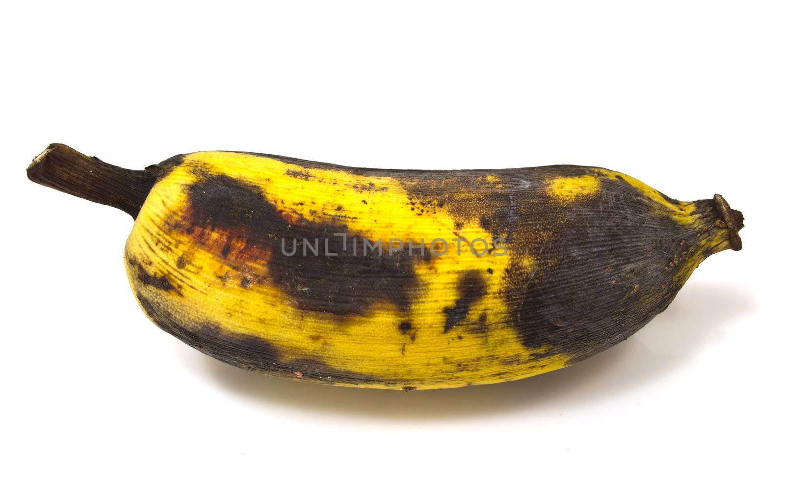a rotting banana isolated on white background by kurapy