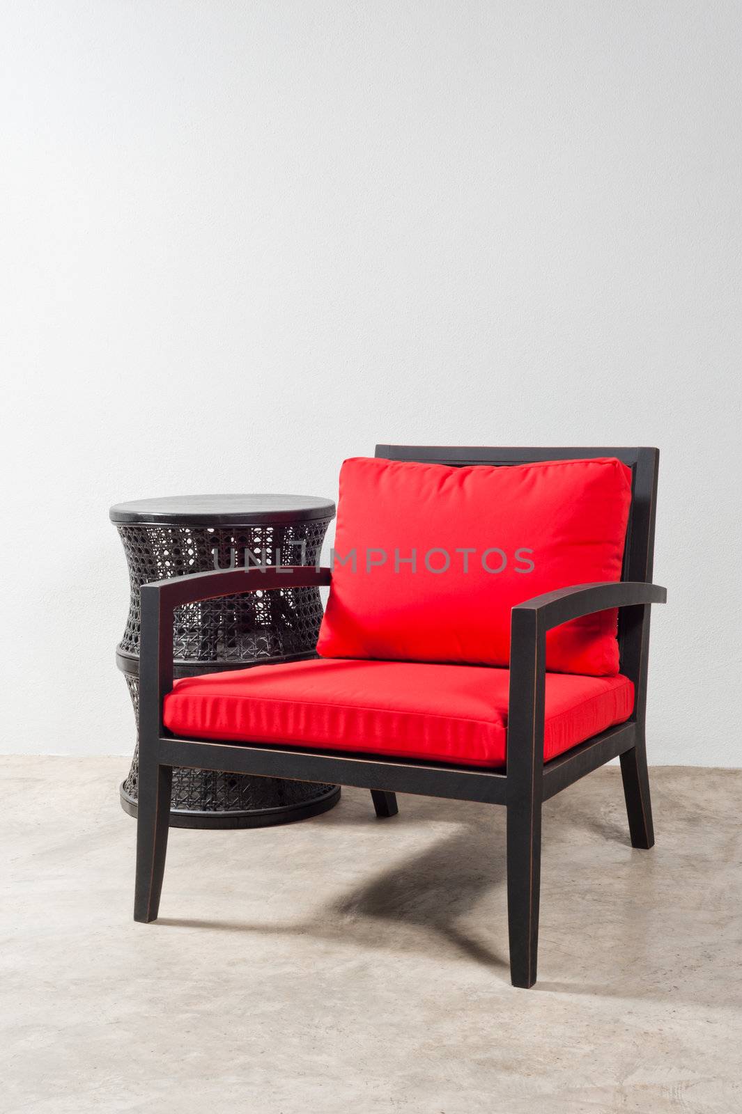 Black red Chair and side table in a bright setting