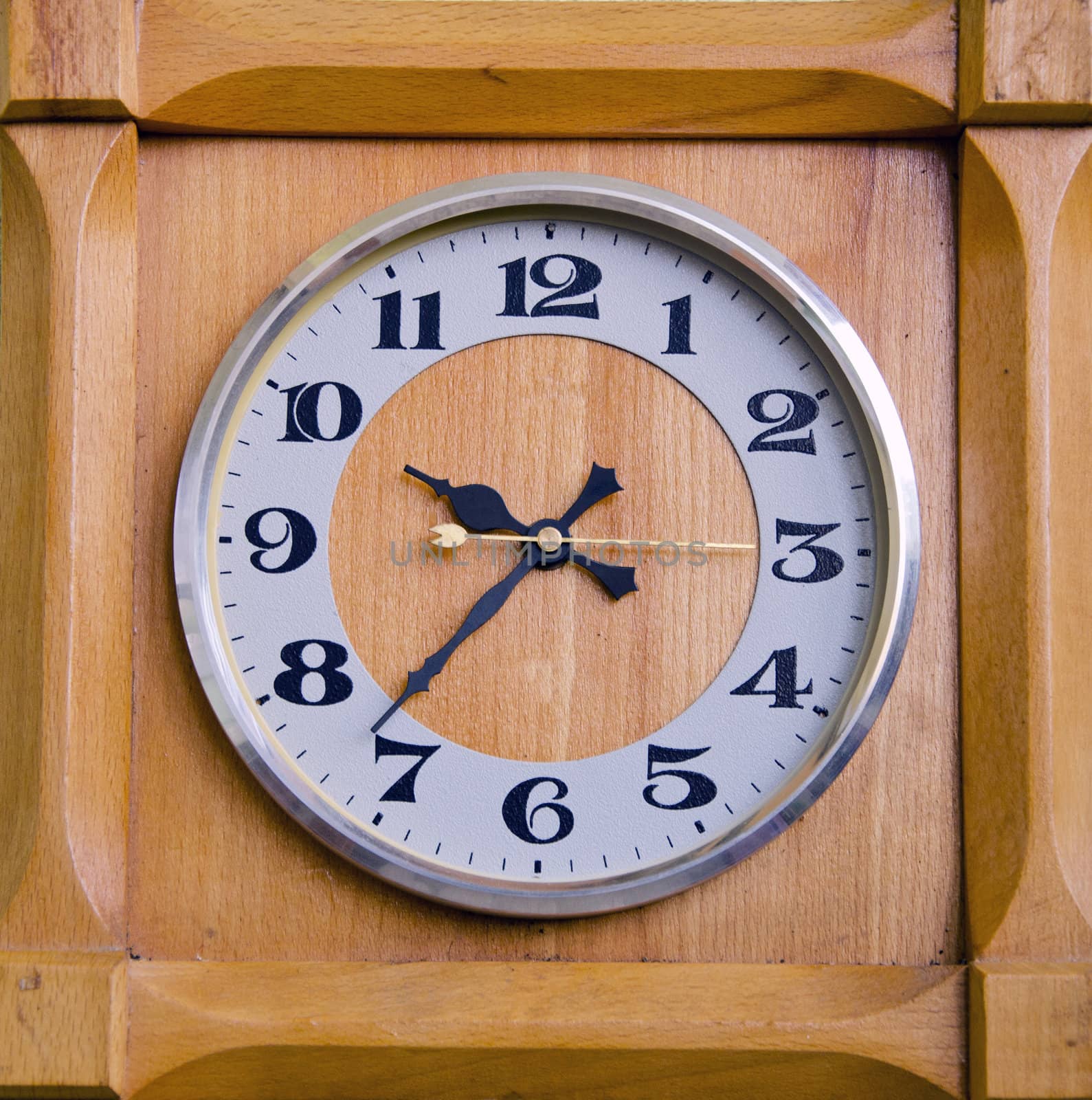 Clock in wooden box showing twentyseven past nine. by sauletas