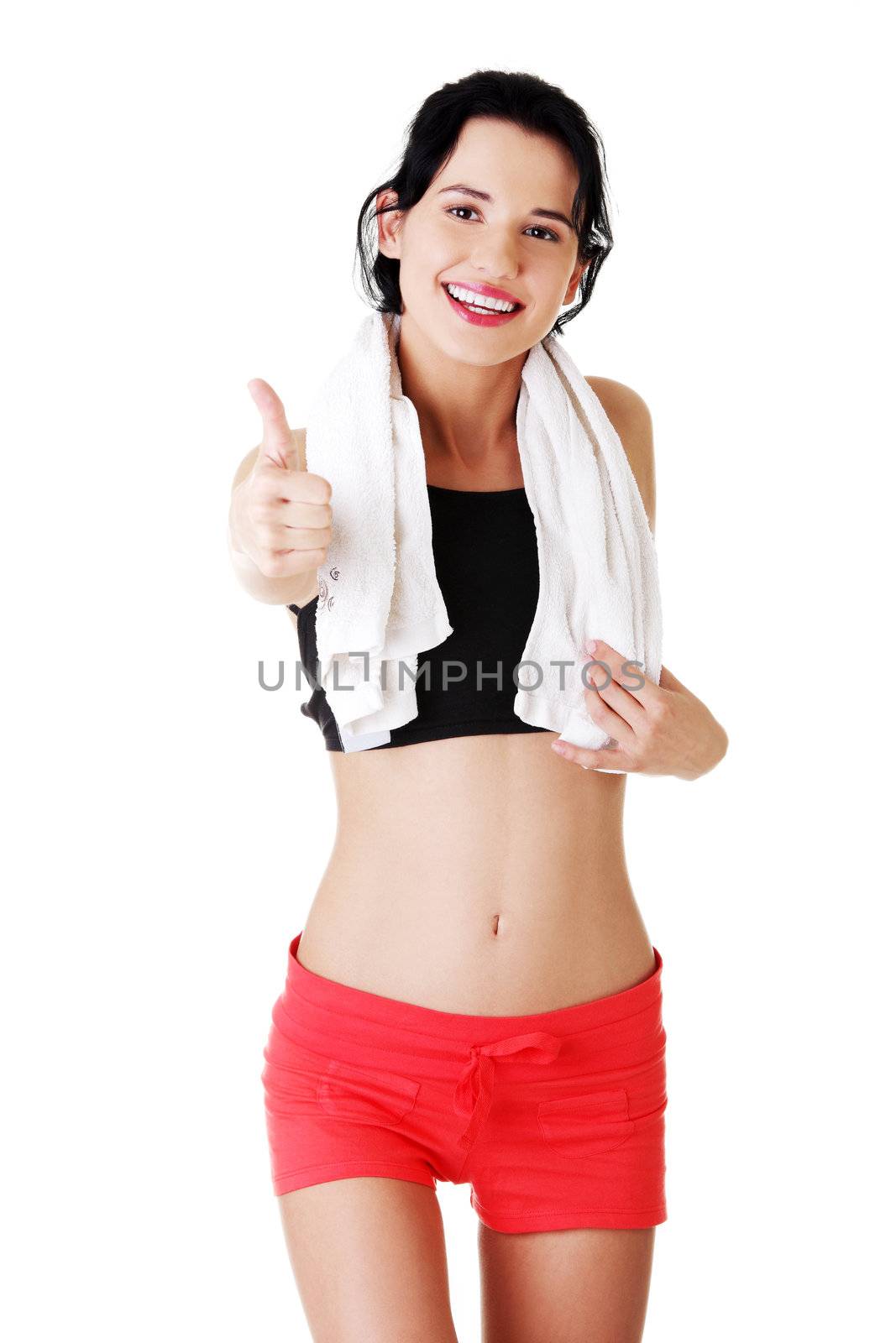 Attractive fitness woman in sport clothes gesturing thumbs up, isolated on white