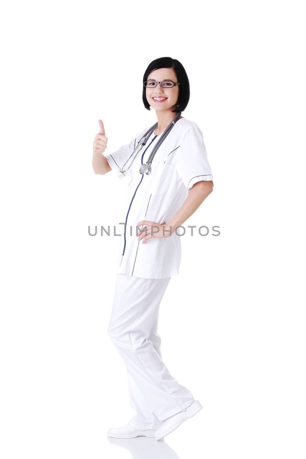 Full portrait of young female doctor or nurse gesturing OK