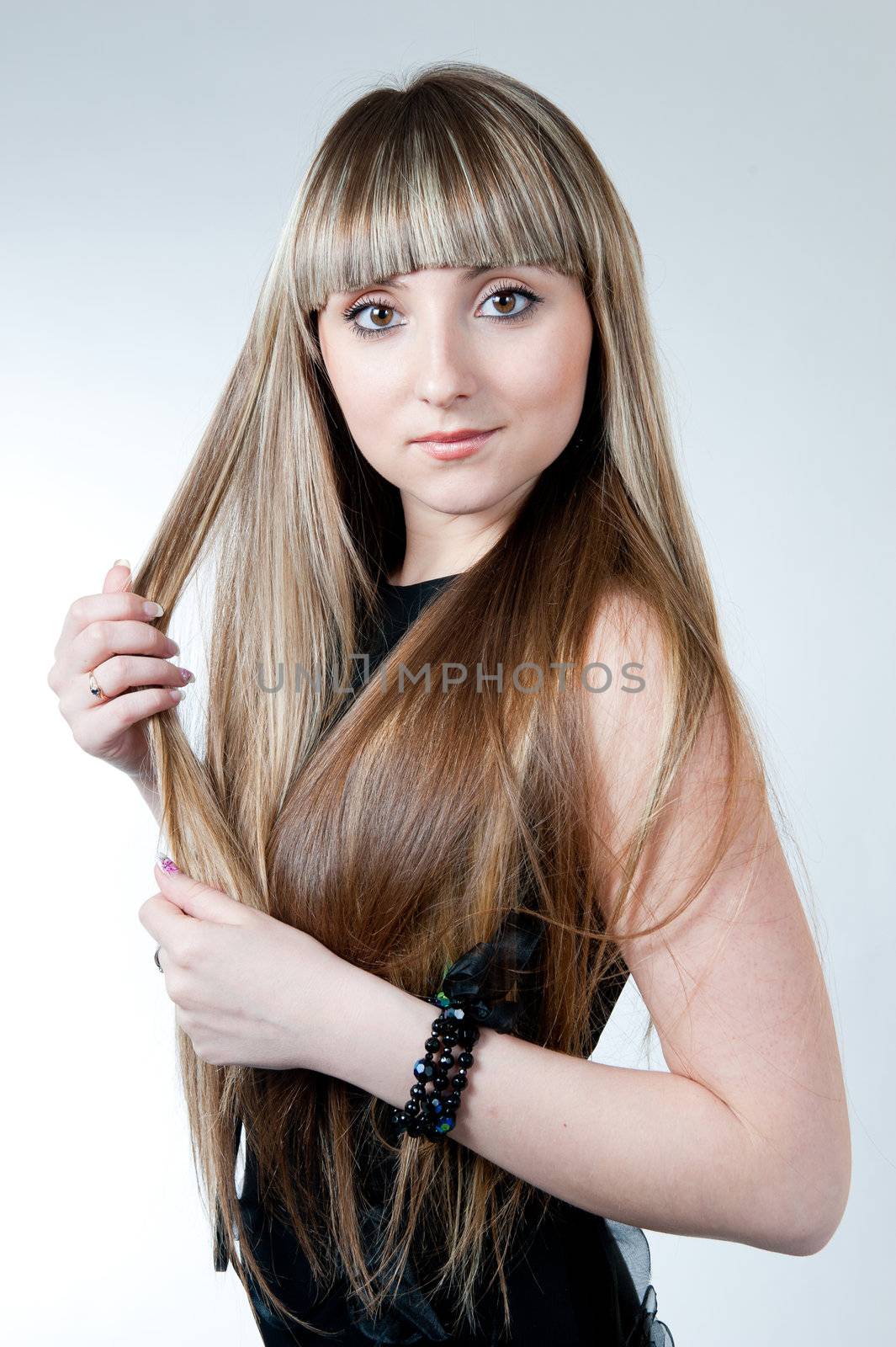 The beautiful girl in black dress isolated on white