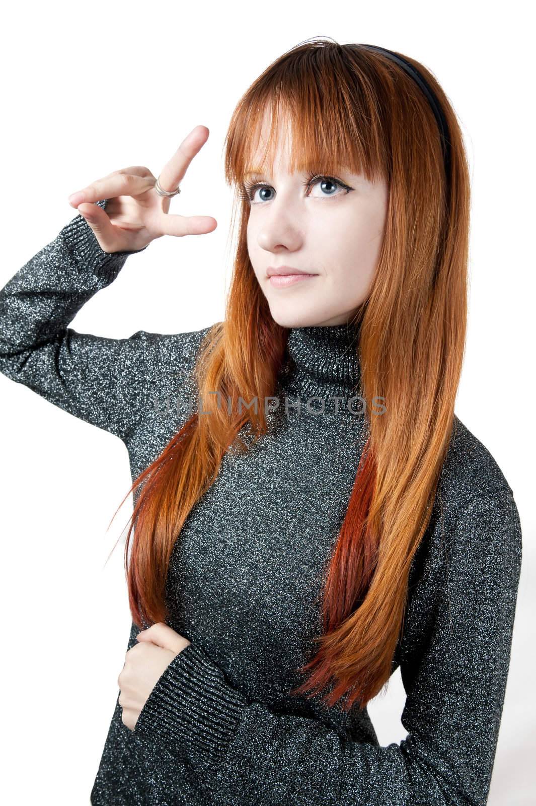 The beautiful girl with red long hair in a sweater isolated on white