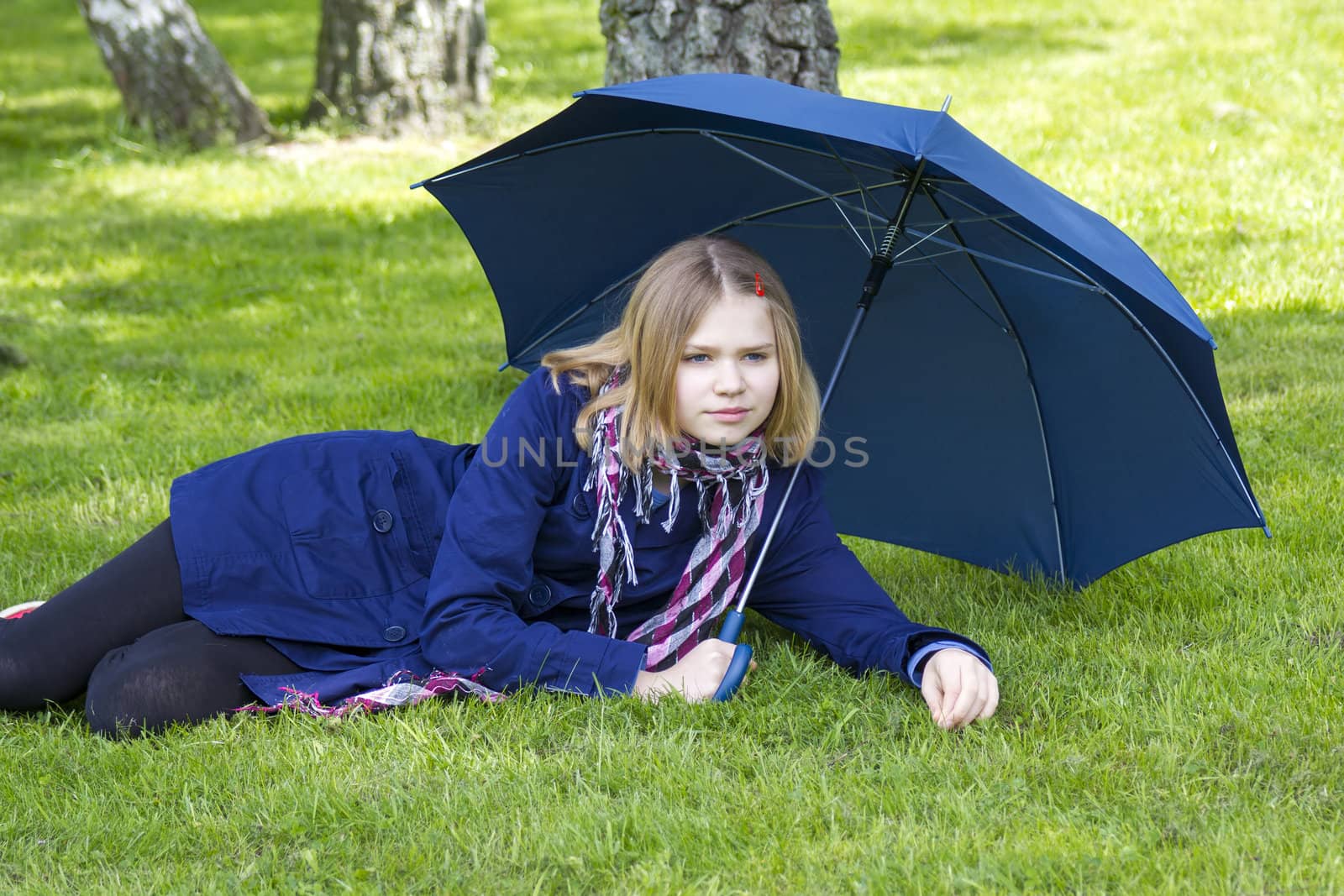 little girl lying on grass  by miradrozdowski