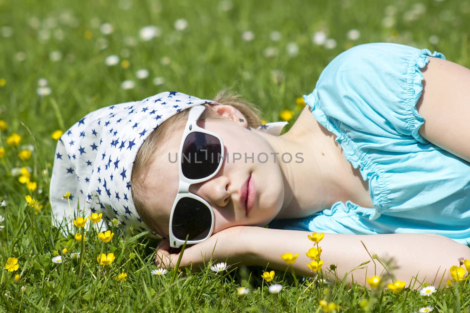 little girl lying on grass 