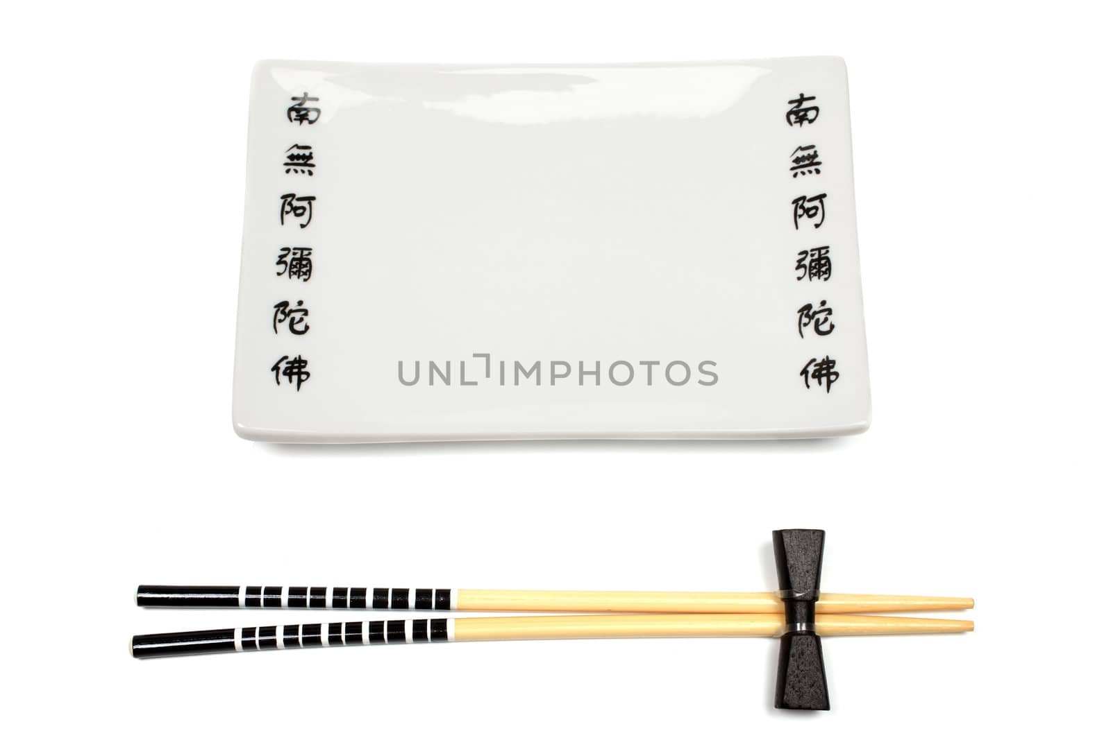 Unused japanese chopsticks and dishware isolated on white background.
