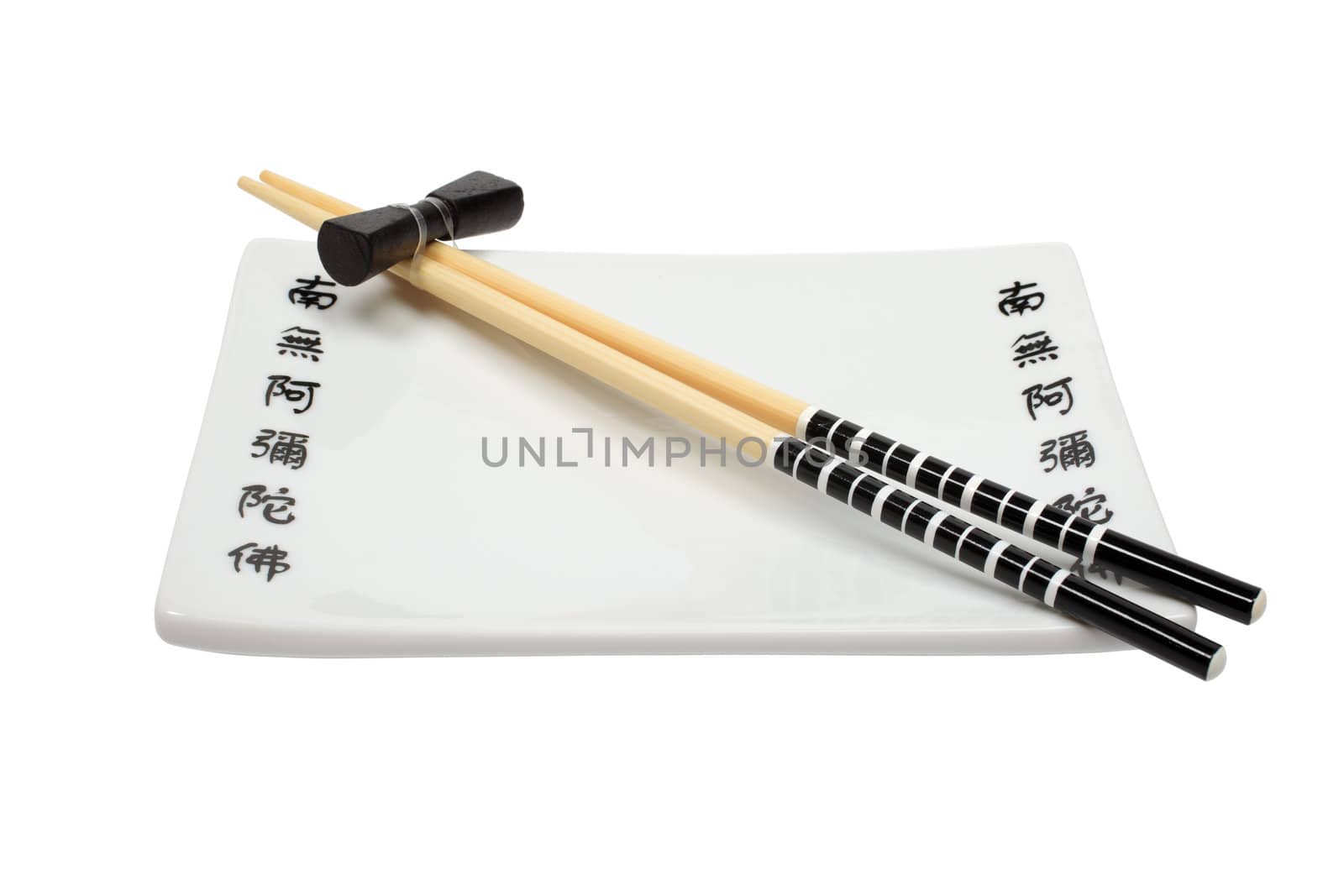 Unused asian chopsticks and plate isolated on white background.
