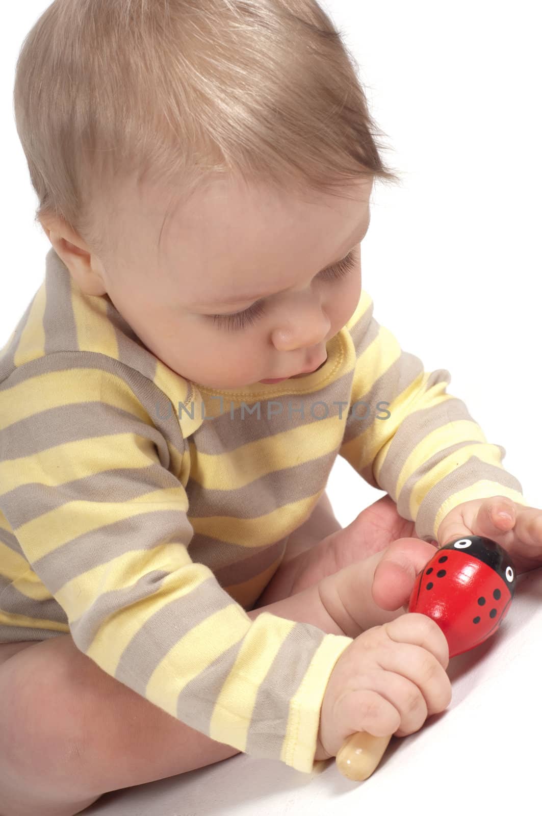 Little cute boy with toy in studio