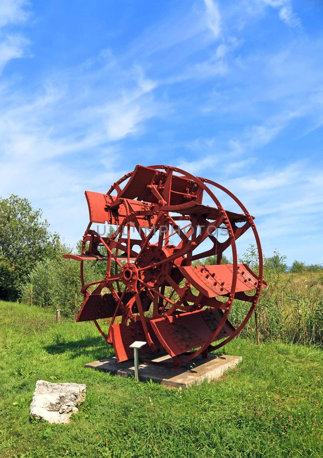 Watermill wheel made of metal. Switzerland, Europe. by borodaev
