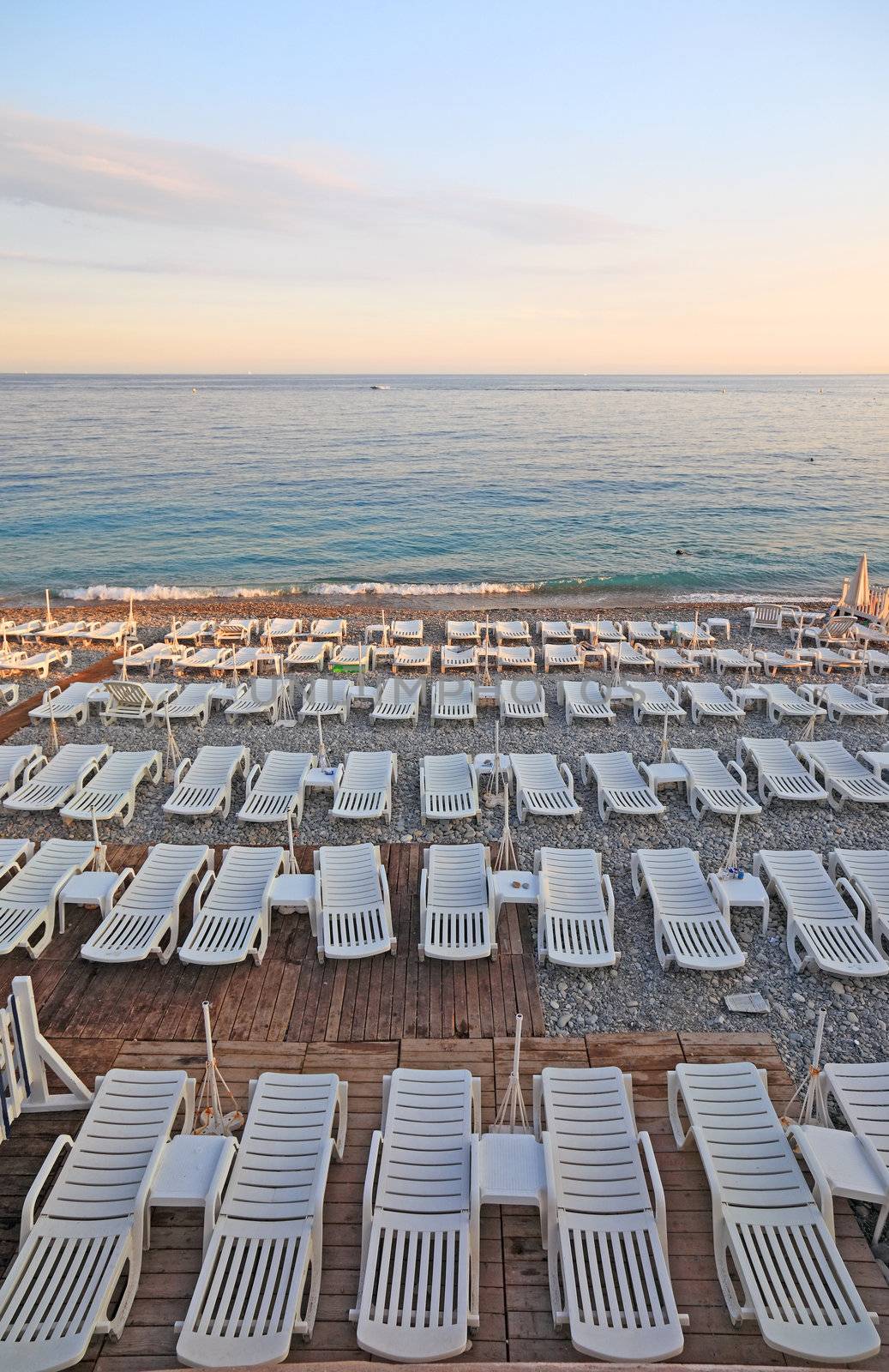 Lot of deck-chairs at the beach of city of Nice, France, Cote d'Azur.