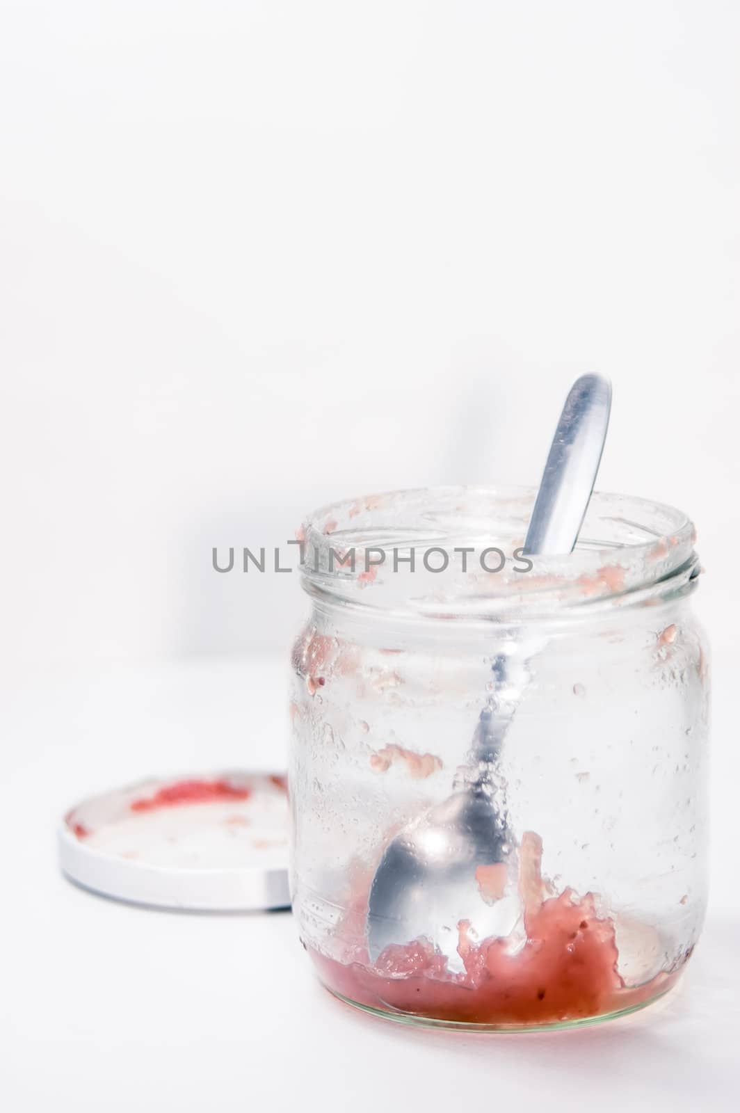 Empty marmalade jar and spoon by saap585