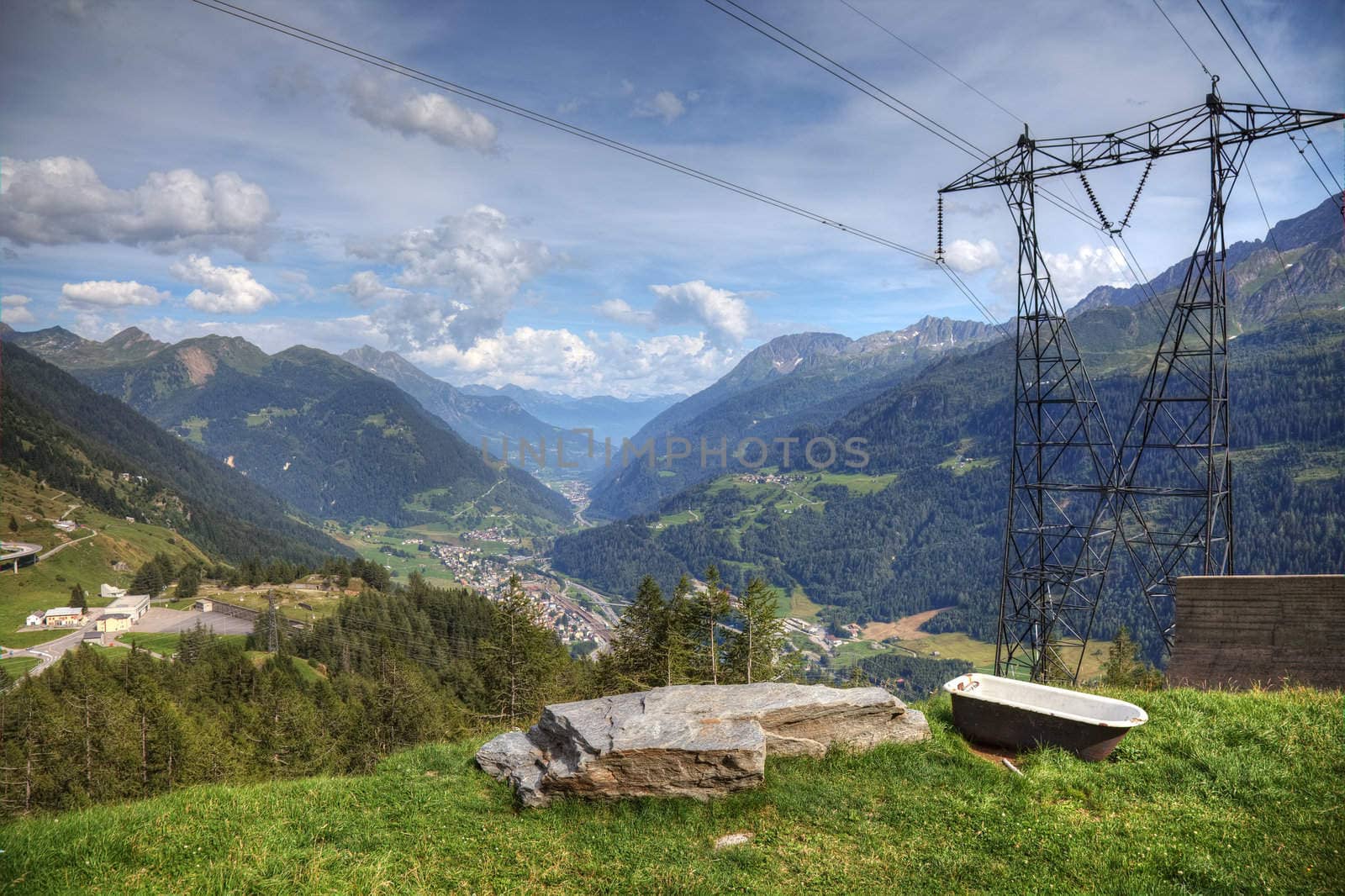 Modern aerial view of swiss alps - powerline, roads and strange bath.