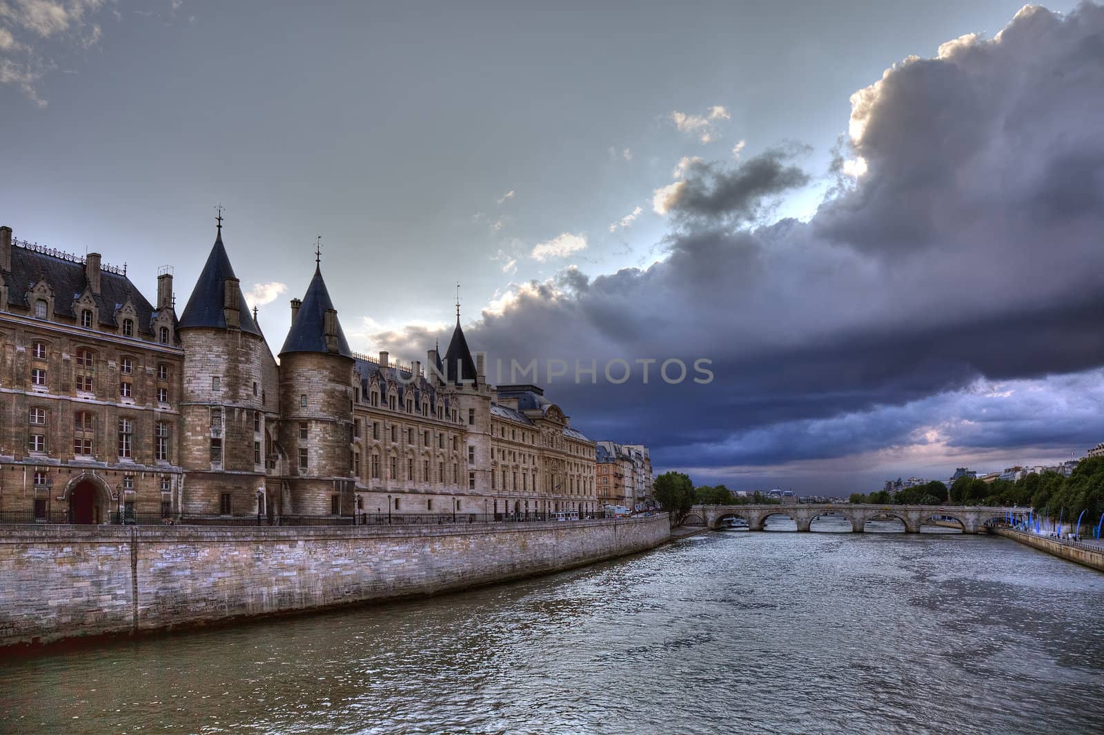 Conciergerie before rain in Paris, dramatic cloudscape. by borodaev