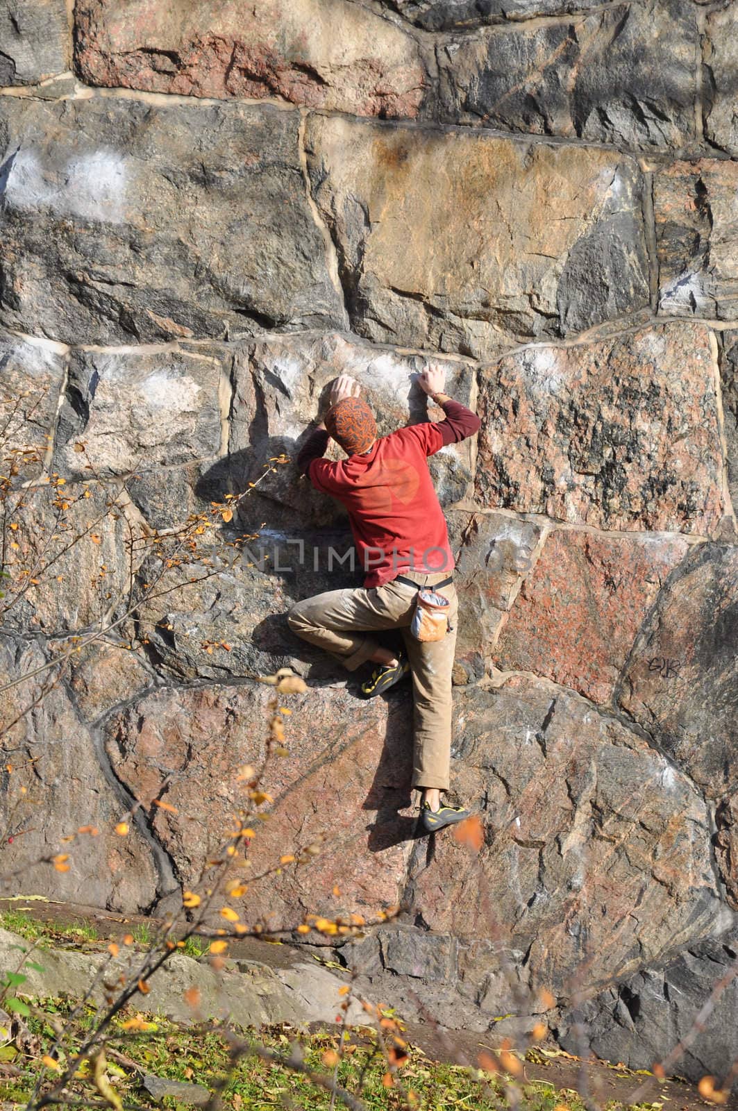 A young man climbing a wall in Stockholm, Sweden