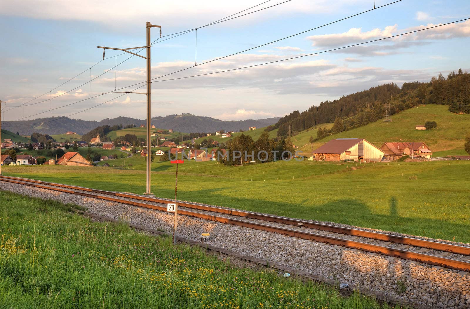 Railroad in swiss Alps before sunset.