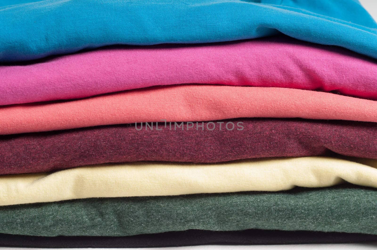 Multicolored clothes stacked